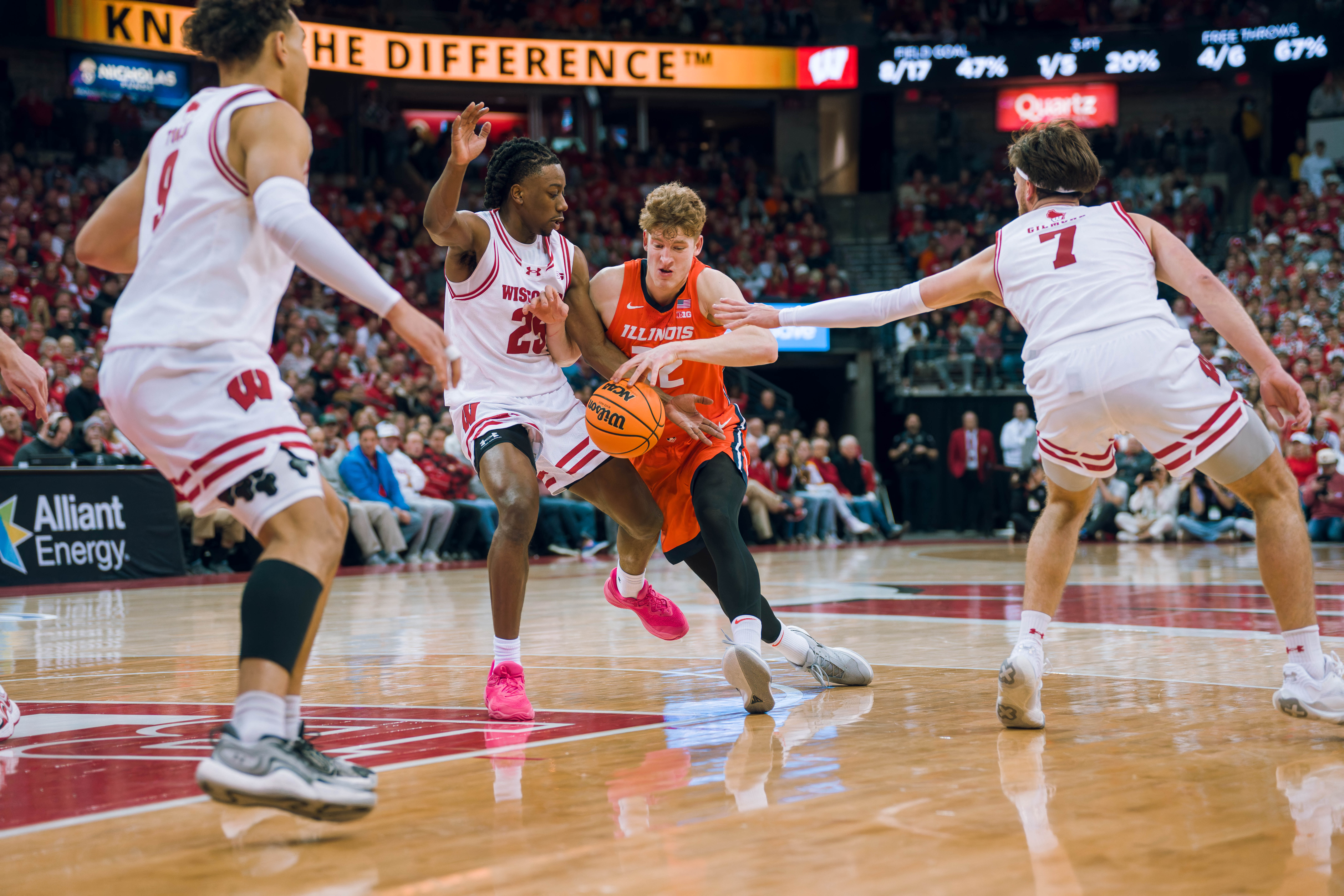 Illinois Fighting Illini guard Kasparas Jakucionis #32 drives the lane defended by Wisconsin Badgers guard John Blackwell #25 at The Kohl Center on February 18, 2025 in Madison, Wisconsin. Photography by Ross Harried for Second Crop Sports.