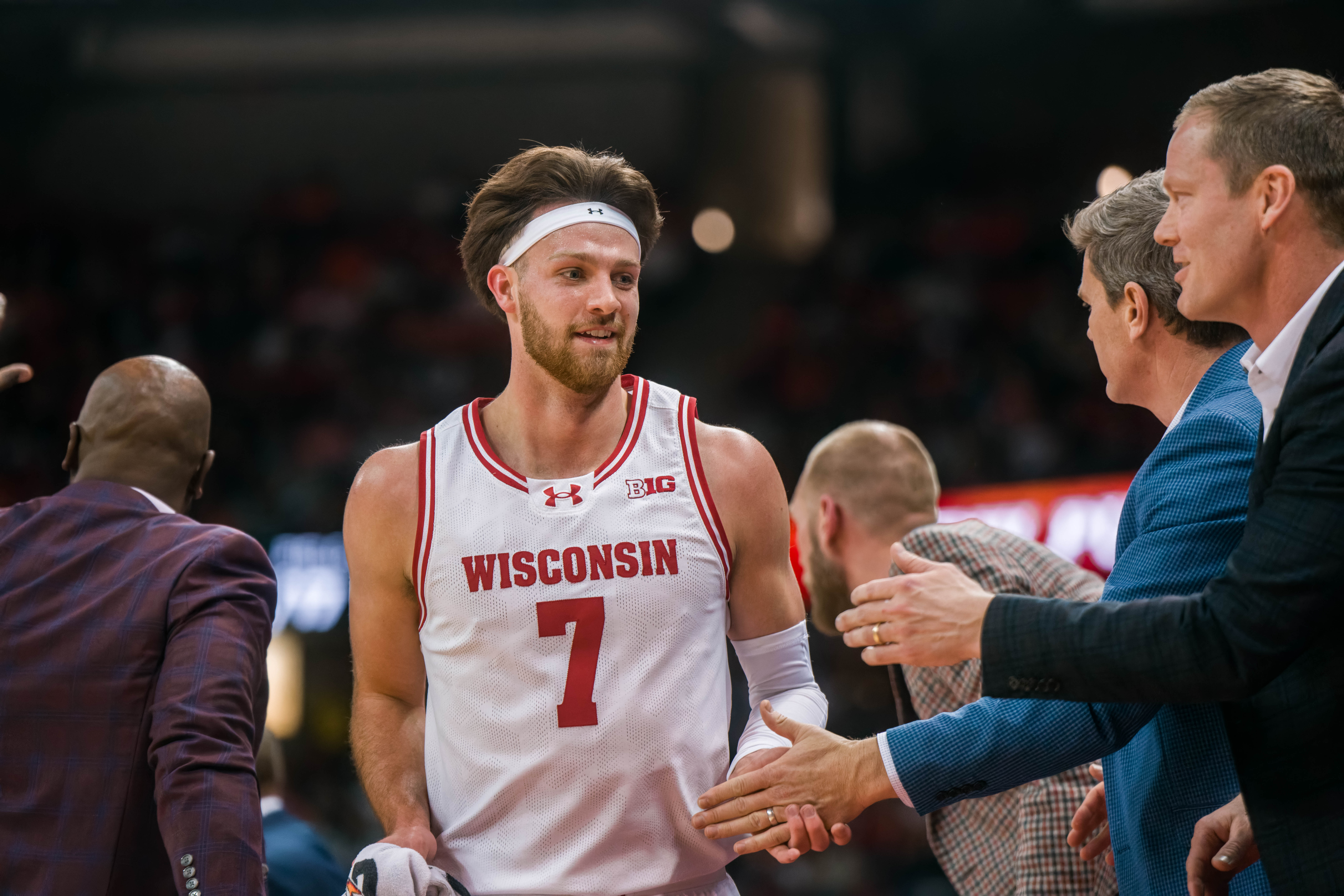 Wisconsin Badgers forward Carter Gilmore #7 receives praise from the bench after a substitution against the Illinois Fighting Illini at The Kohl Center on February 18, 2025 in Madison, Wisconsin. Photography by Ross Harried for Second Crop Sports.