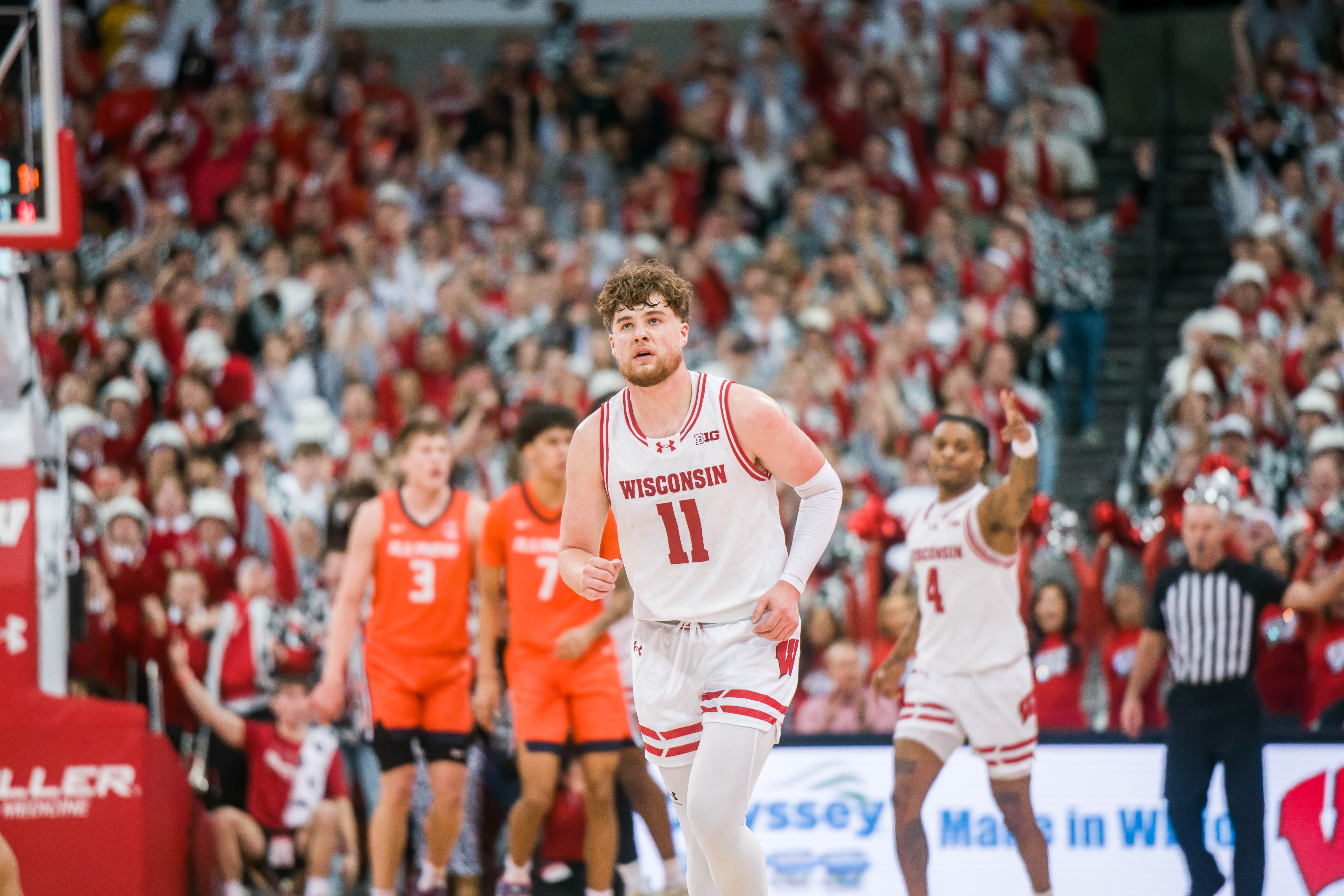 Wisconsin Badgers guard Max Klesmit #11 looks towards the scoreboard after draining a three pointer against the Illinois Fighting Illini at The Kohl Center on February 18, 2025 in Madison, Wisconsin. Photography by Ross Harried for Second Crop Sports.