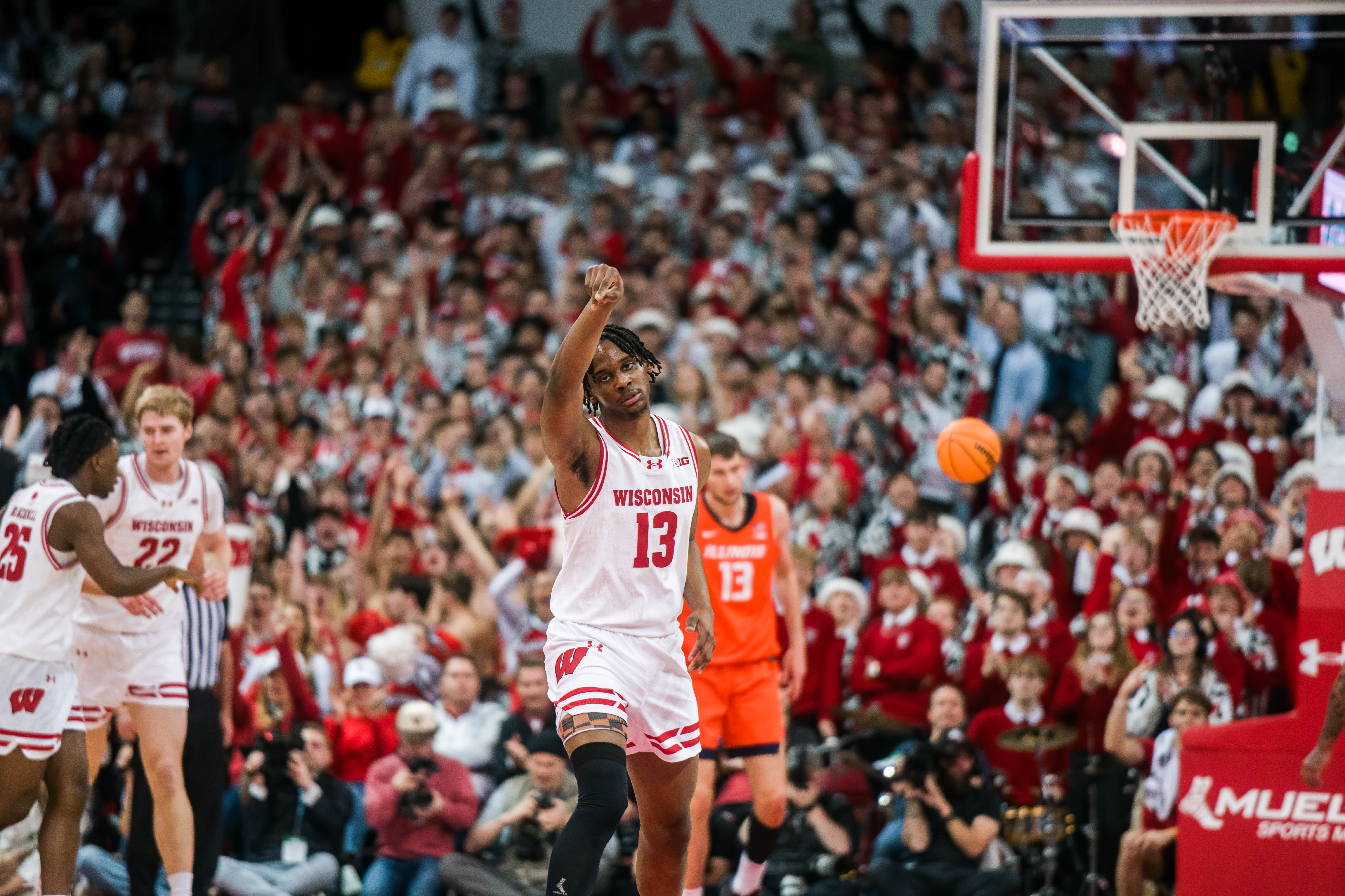 Wisconsin Badgers forward Xavier Amos #13 holds his form after knocking down a three pointer against the Illinois Fighting Illini at The Kohl Center on February 18, 2025 in Madison, Wisconsin. Photography by Ross Harried for Second Crop Sports.