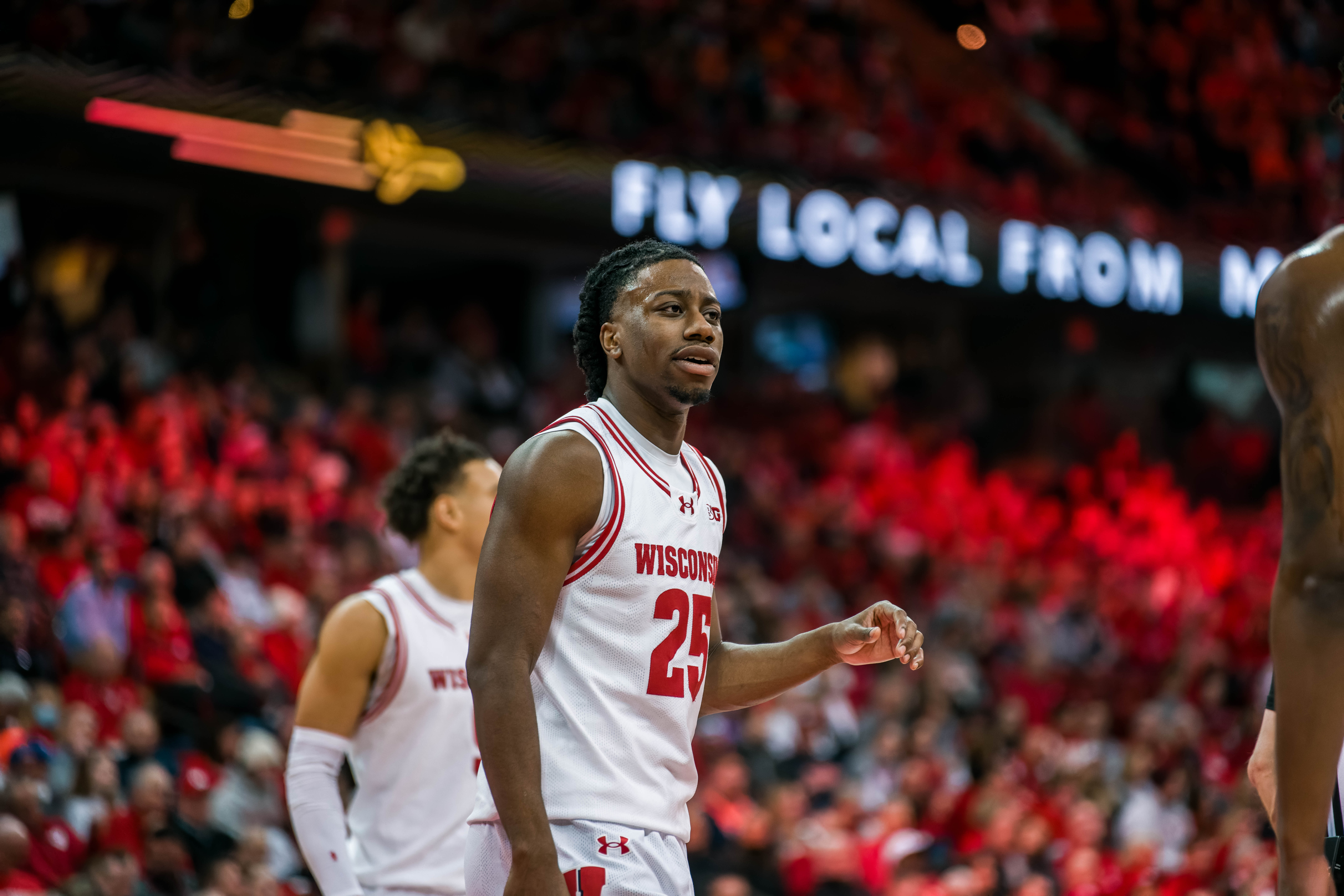 Wisconsin Badgers guard John Blackwell #25 talks it over with a teammate against the Illinois Fighting Illini at The Kohl Center on February 18, 2025 in Madison, Wisconsin. Photography by Ross Harried for Second Crop Sports.