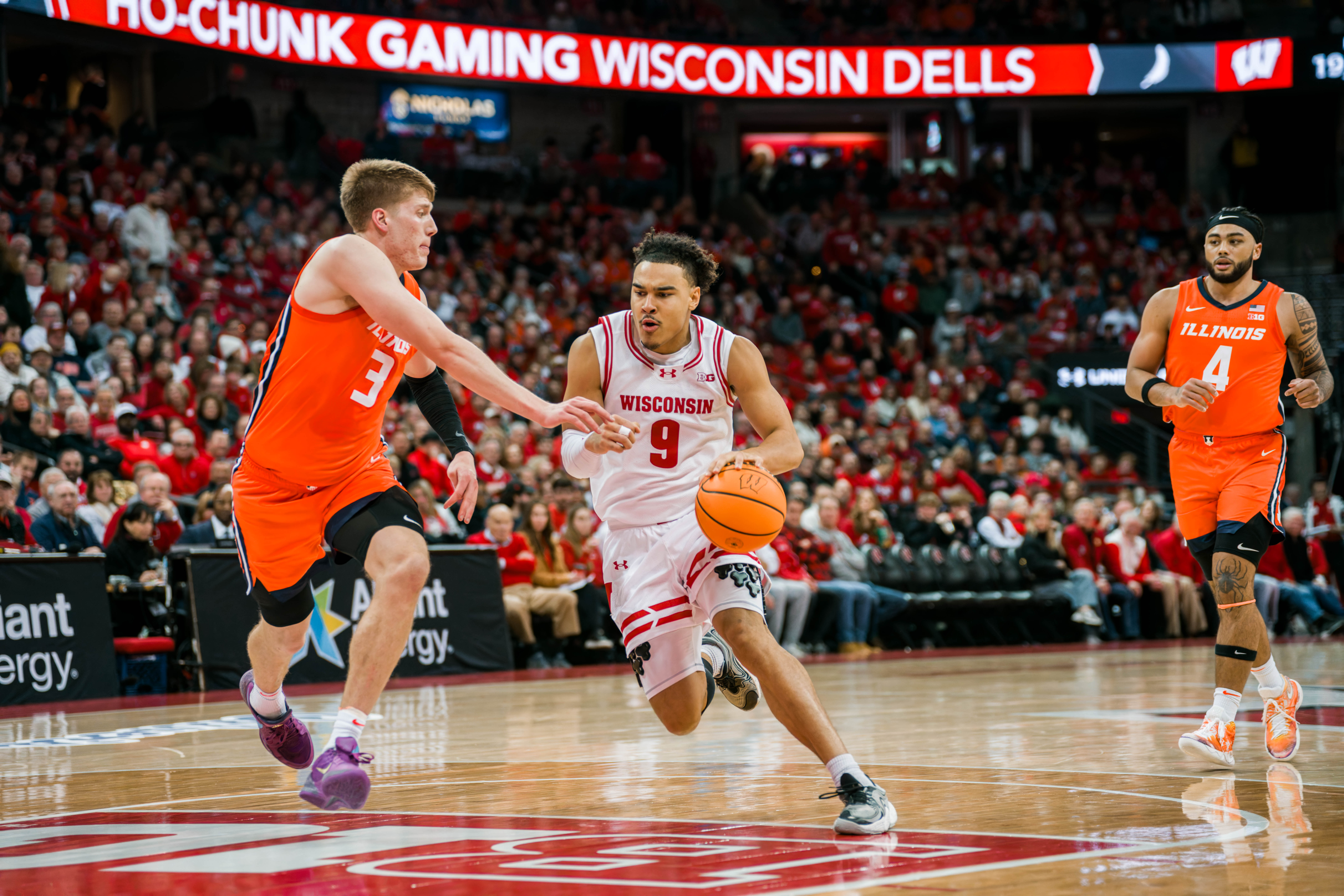 Wisconsin Badgers guard John Tonje #9 drives the lane while defended by Illinois Fighting Illini forward Ben Humrichous #3 at The Kohl Center on February 18, 2025 in Madison, Wisconsin. Photography by Ross Harried for Second Crop Sports.