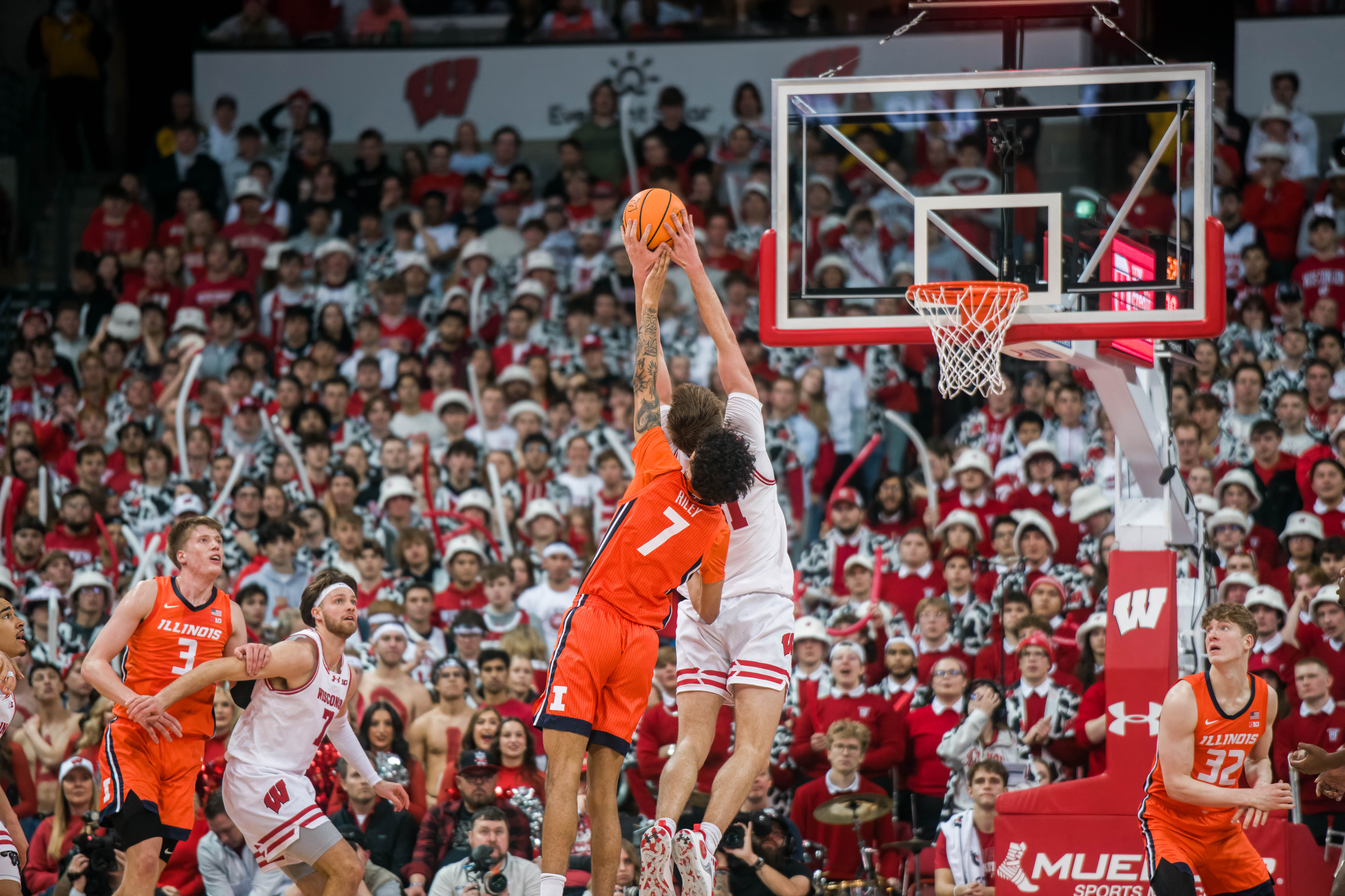 Wisconsin Badgers forward Nolan Winter #31 snatches a rebound over Illinois Fighting Illini forward Will Riley #7 at The Kohl Center on February 18, 2025 in Madison, Wisconsin. Photography by Ross Harried for Second Crop Sports.