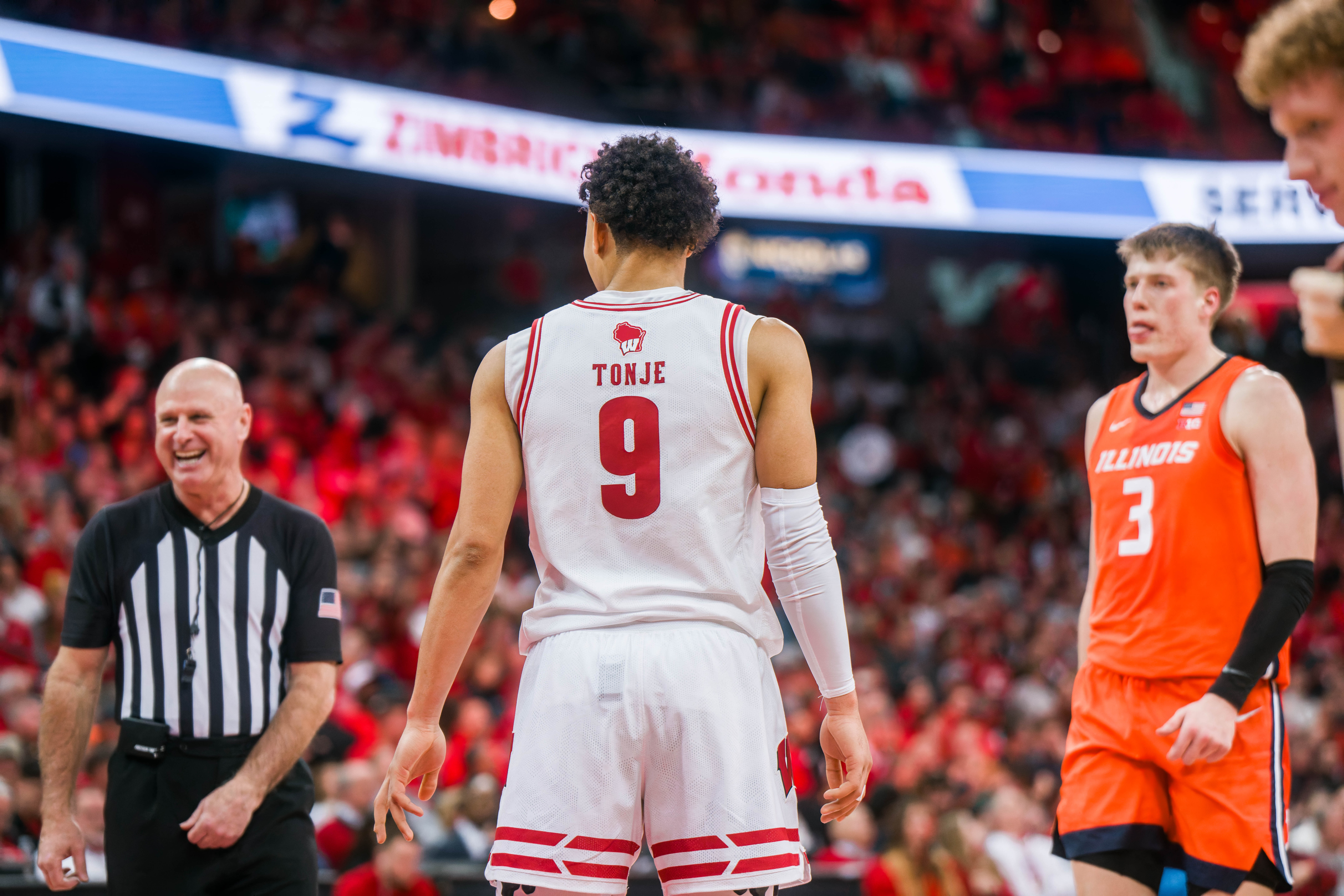 Wisconsin Badgers guard John Tonje #9 cracks a joke with the referee during a game against the Illinois Fighting Illini at The Kohl Center on February 18, 2025 in Madison, Wisconsin. Photography by Ross Harried for Second Crop Sports.