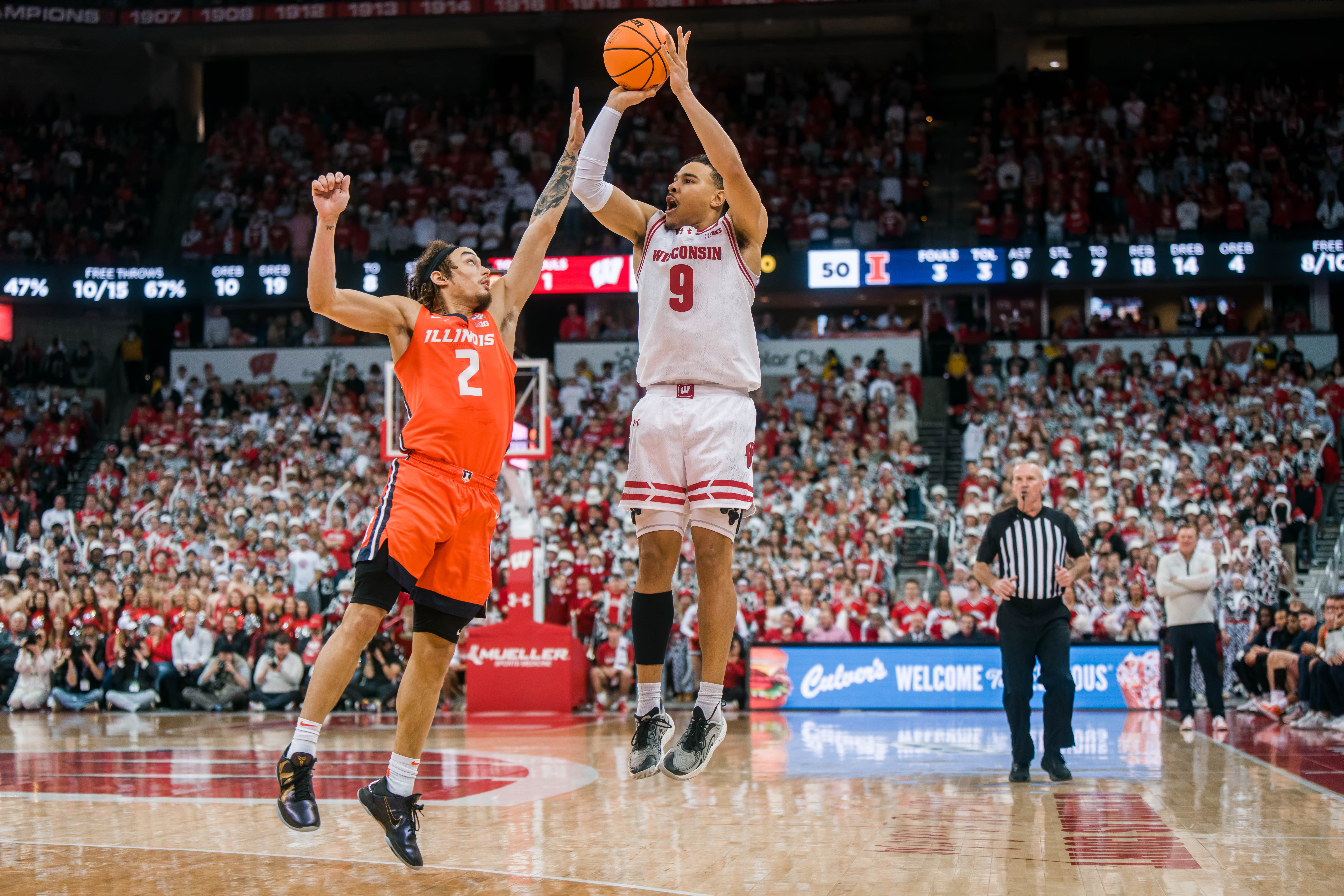 Wisconsin Badgers guard John Tonje #9 attempts a three pointer while defended by Illinois Fighting Illini guard Dra Gibbs-Lawhorn #2 at The Kohl Center on February 18, 2025 in Madison, Wisconsin. Photography by Ross Harried for Second Crop Sports.