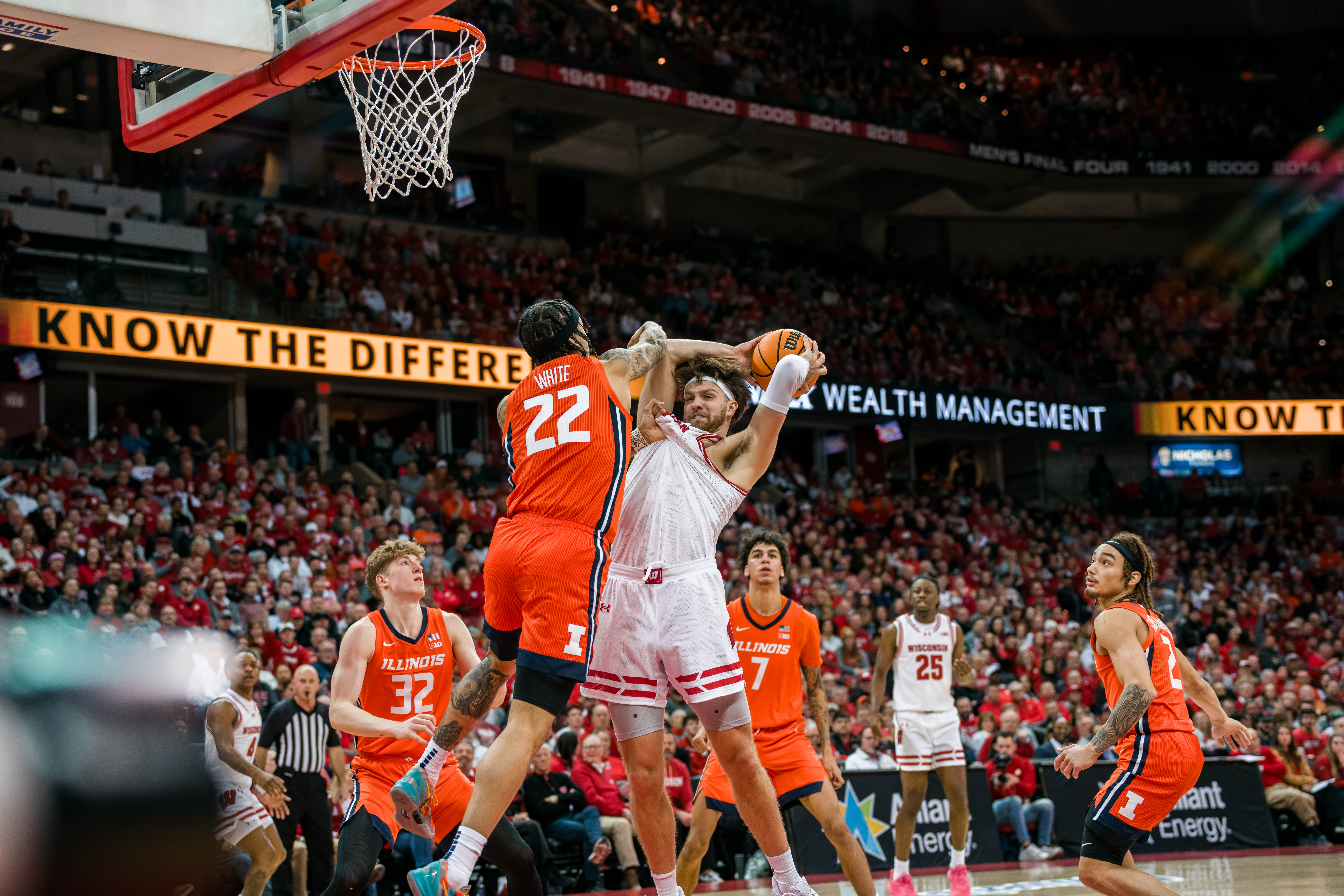 Wisconsin Badgers forward Carter Gilmore #7 is fouled hard by Illinois Fighting Illini guard Tre White #22 at The Kohl Center on February 18, 2025 in Madison, Wisconsin. Photography by Ross Harried for Second Crop Sports.