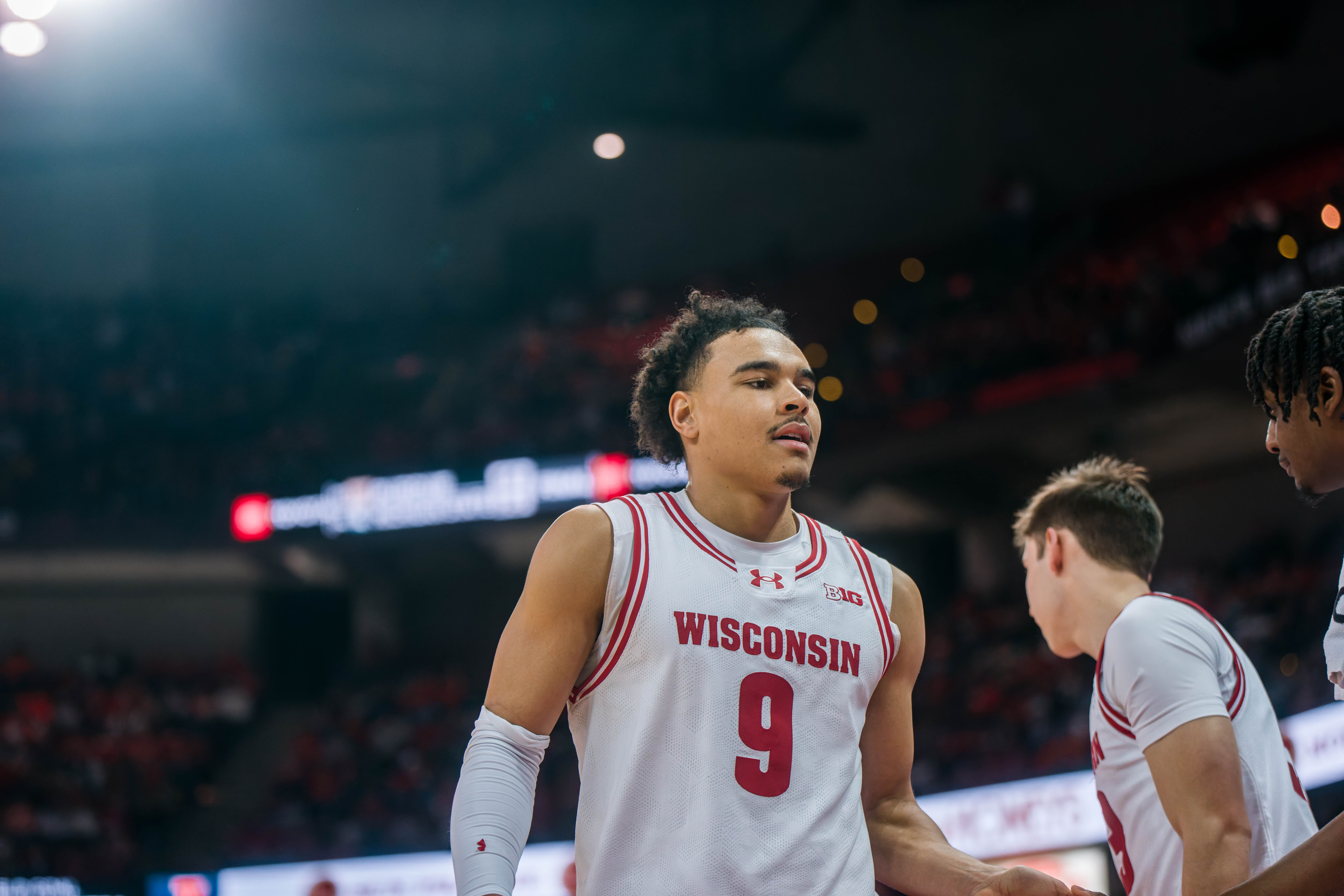 Wisconsin Badgers guard John Tonje #9 heads to the bench against the llinois Fighting Illini at The Kohl Center on February 18, 2025 in Madison, Wisconsin. Photography by Ross Harried for Second Crop Sports.