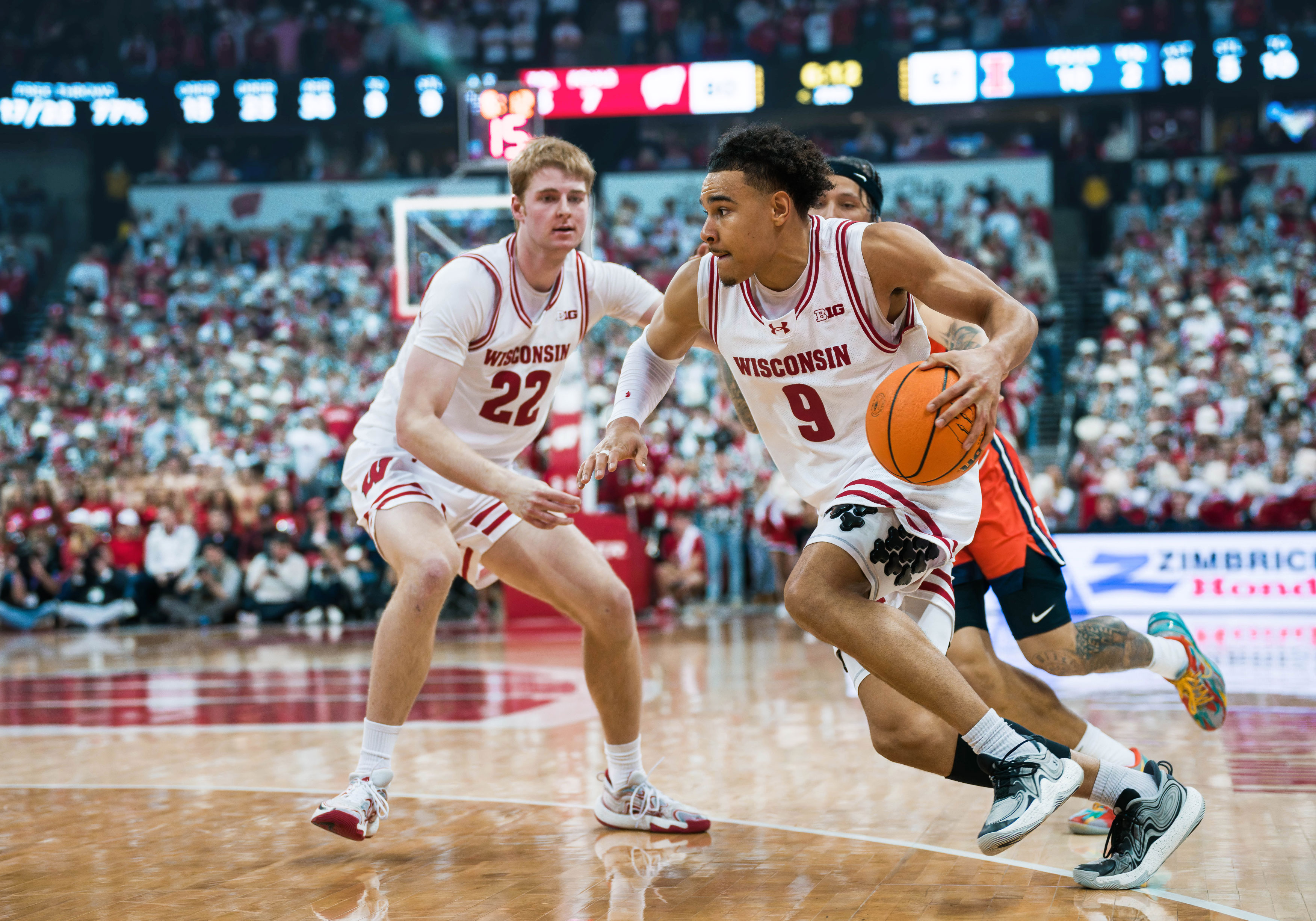 Wisconsin Badgers guard John Tonje #9 drives the baseline with a helpful pick from forward Steven Crowl #22 Wisconsin Badgers vs. Illinois Fighting Illini at The Kohl Center on February 18, 2025 in Madison, Wisconsin. Photography by Ross Harried for Second Crop Sports.