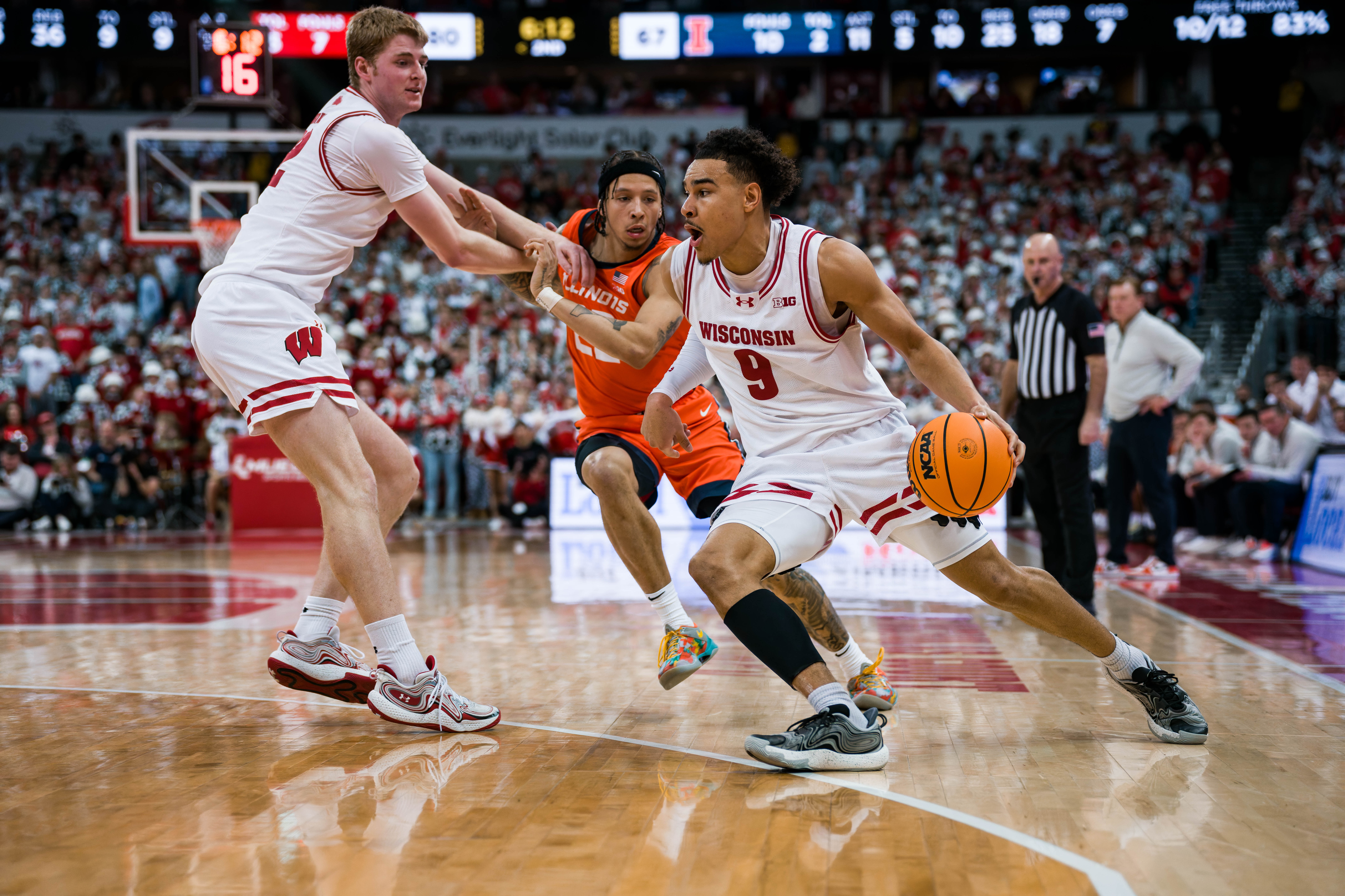 Wisconsin Badgers guard John Tonje #9 drives the baseline with a helpful pick from forward Steven Crowl #22 Wisconsin Badgers vs. Illinois Fighting Illini at The Kohl Center on February 18, 2025 in Madison, Wisconsin. Photography by Ross Harried for Second Crop Sports.