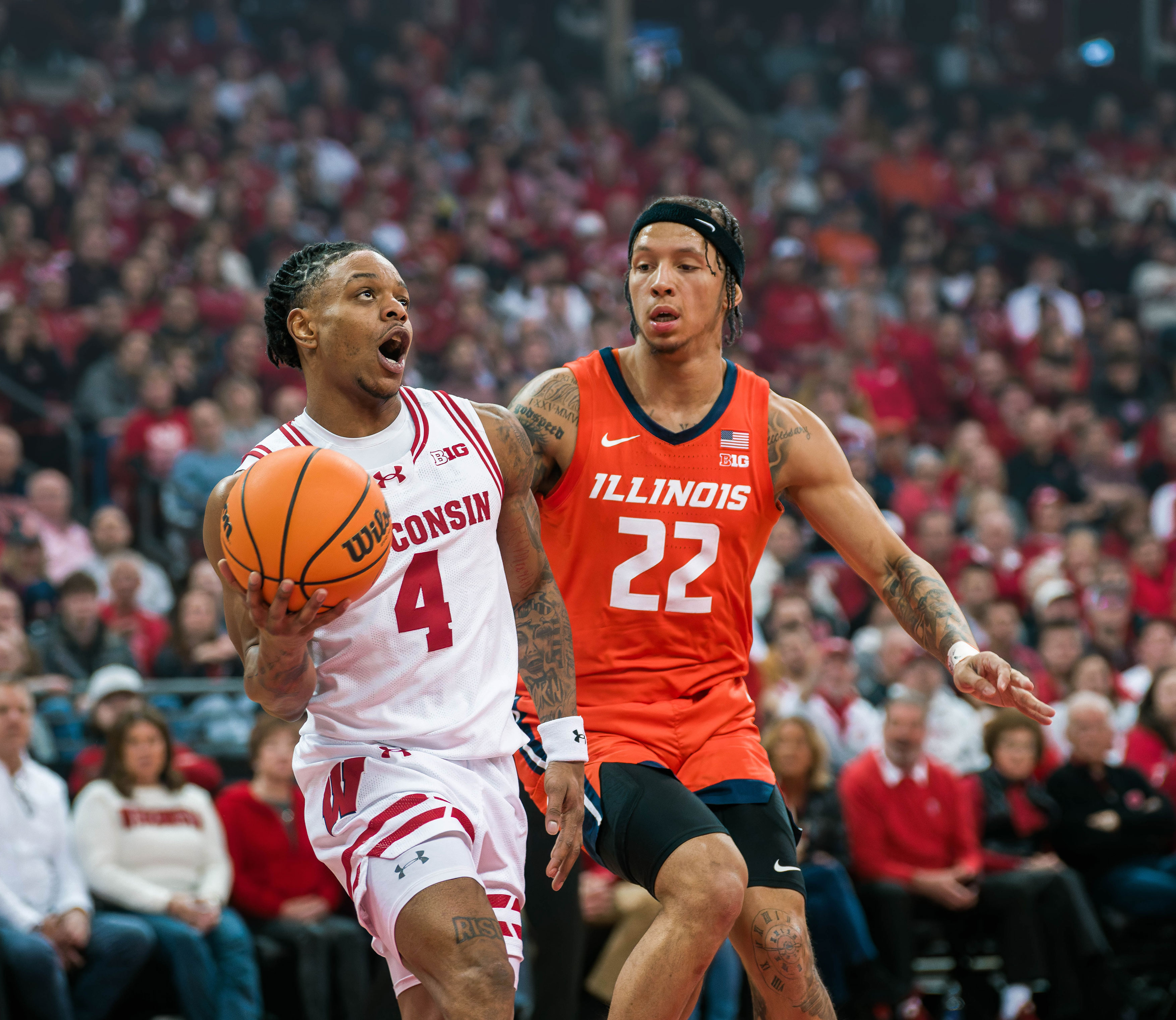 Wisconsin Badgers guard Kamari McGee #4 drives the baseline against Illinois Fighting Illini guard Tre White #22 at The Kohl Center on February 18, 2025 in Madison, Wisconsin. Photography by Ross Harried for Second Crop Sports.