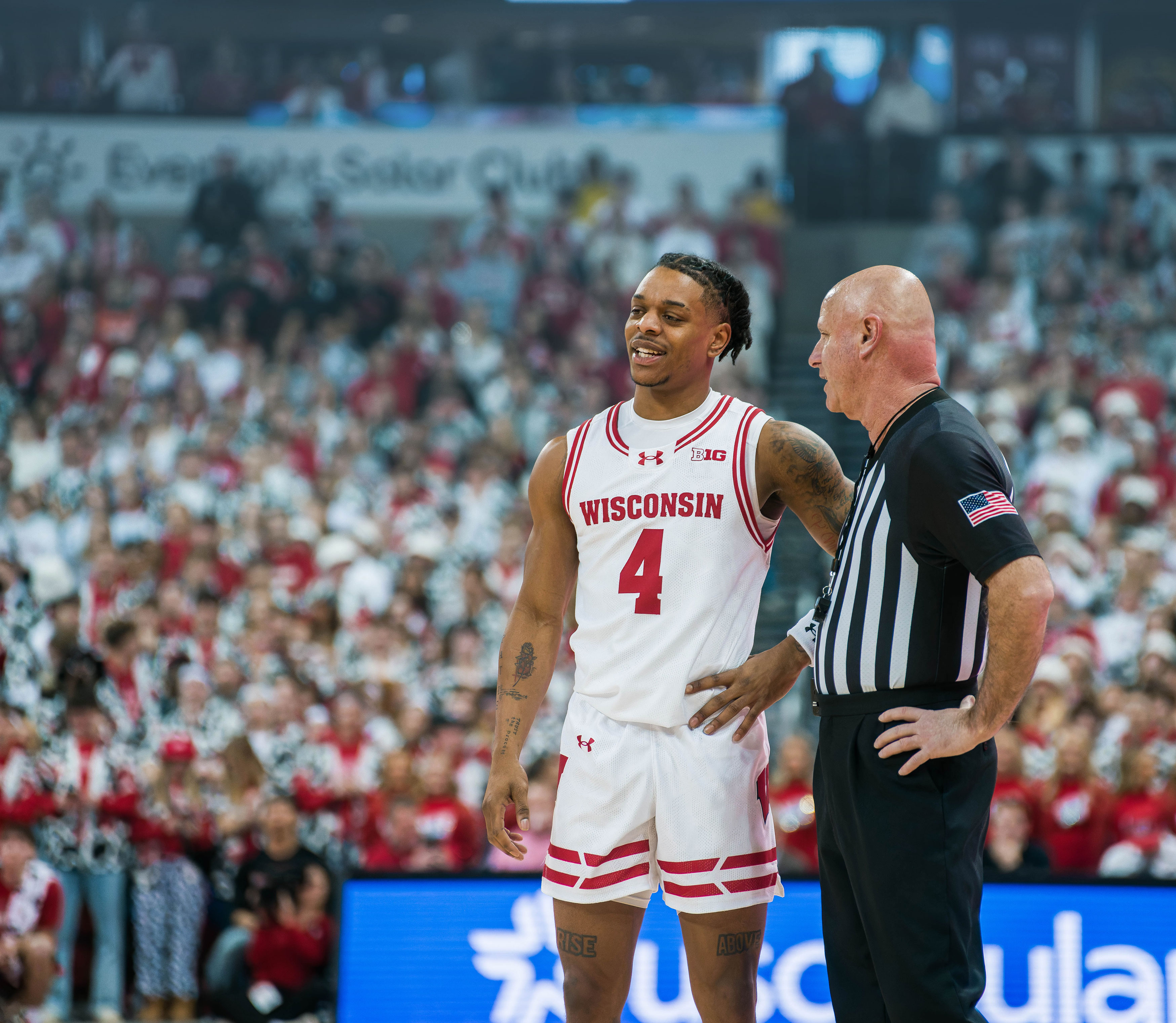 Wisconsin Badgers guard Kamari McGee #4 has a discussion with the referee against the Illinois Fighting Illini at The Kohl Center on February 18, 2025 in Madison, Wisconsin. Photography by Ross Harried for Second Crop Sports.