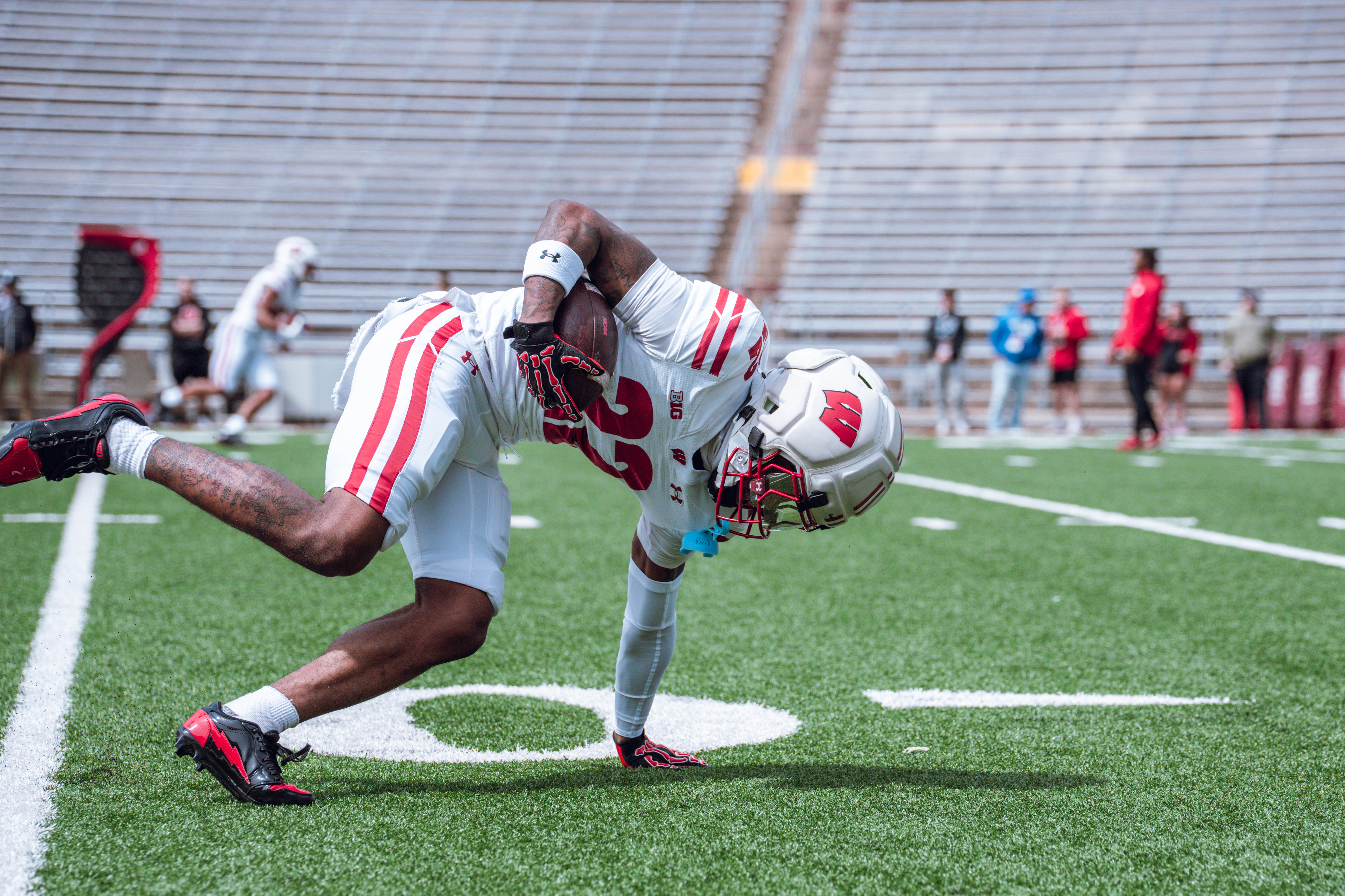Wisconsin Badgers wide receiver Kyan Berry-Johnson #22 keeps his balance during warmups before the Wisconsin Football Spring Showcase at Camp Randall Stadium on April 19, 2025 in Madison, Wisconsin. Photography by Ross Harried for Second Crop Sports.