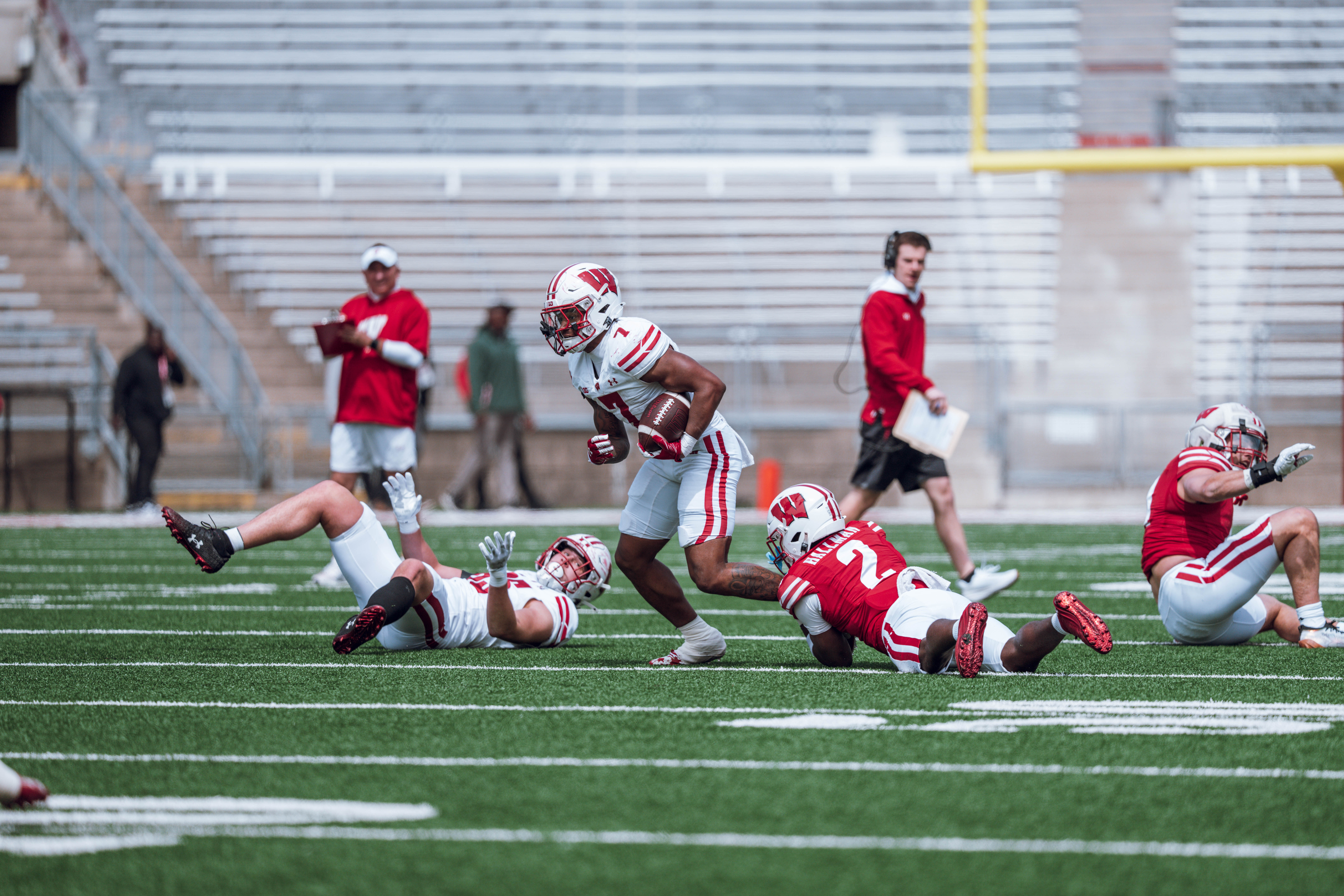 Wisconsin Badgers running back Dilin Jones #7 tries to break free from a Badgers cornerback Ricardo Hallman #2 tackle during the Wisconsin Football Spring Showcase at Camp Randall Stadium on April 19, 2025 in Madison, Wisconsin. Photography by Ross Harried for Second Crop Sports.