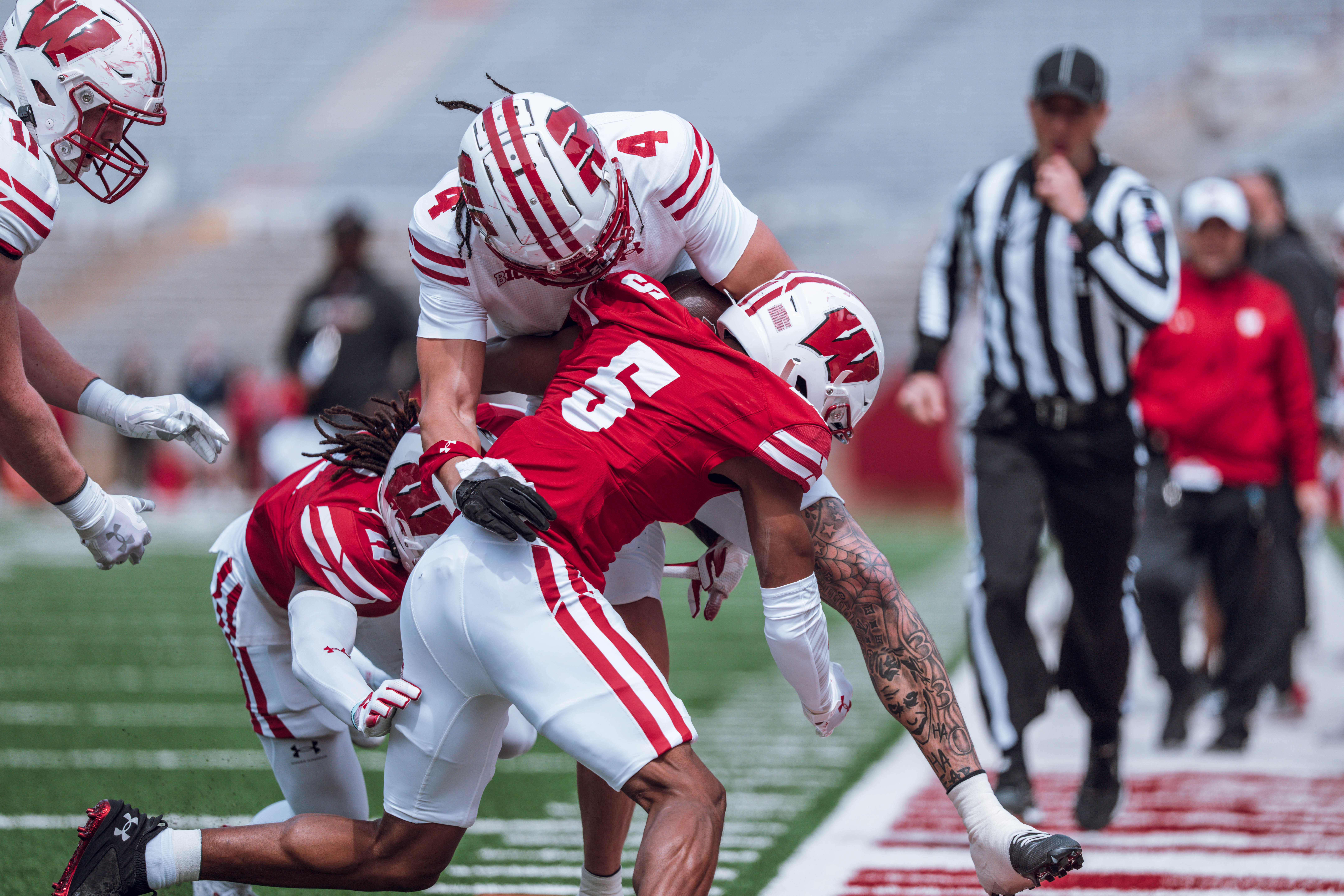 Wisconsin Badgers wide receiver Jayden Ballard #4 is tackled out of bounds by Badgers cornerback D'Yoni Hill #5 during the Wisconsin Football Spring Showcase at Camp Randall Stadium on April 19, 2025 in Madison, Wisconsin. Photography by Ross Harried for Second Crop Sports.