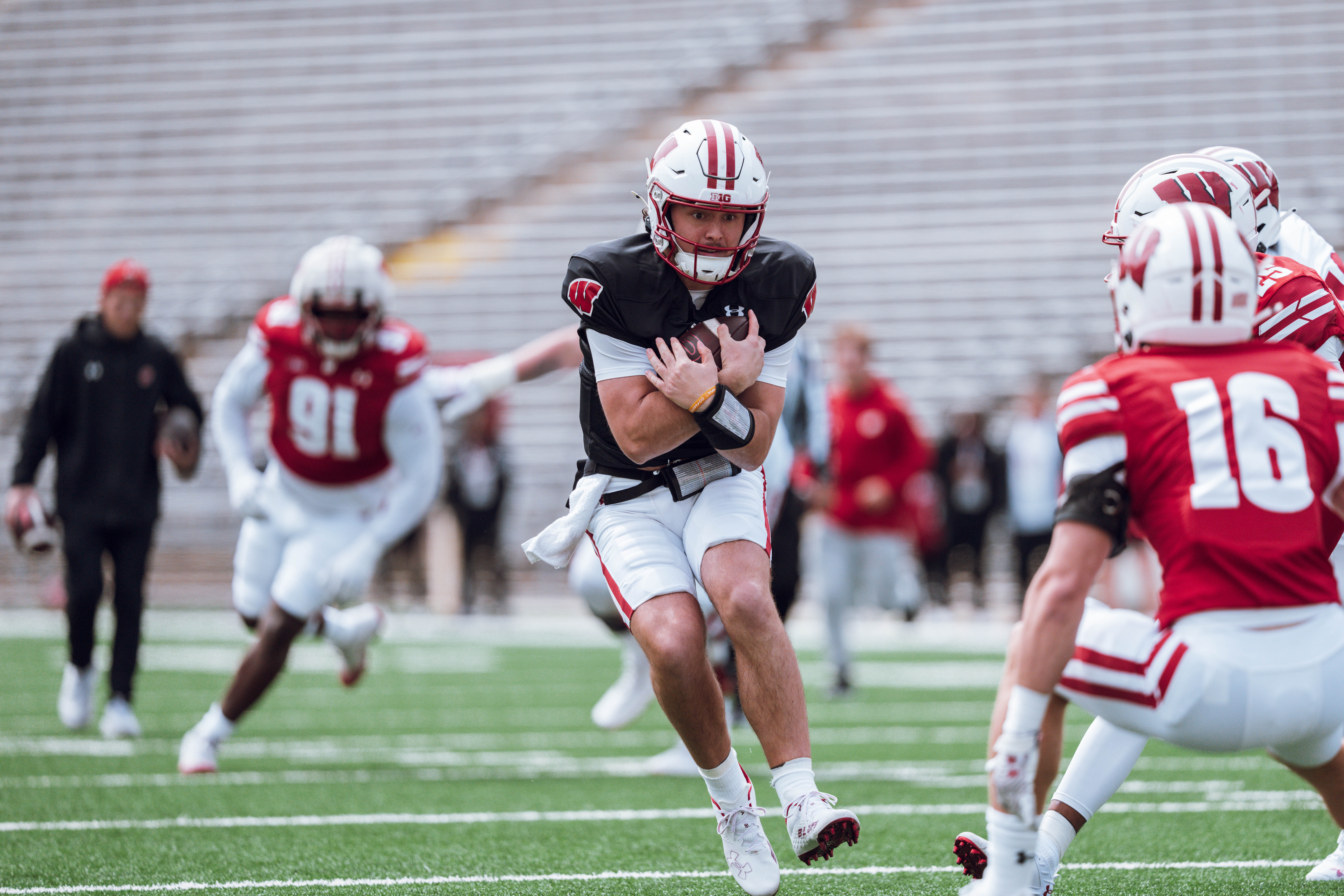 Wisconsin Badgers quarterback Danny O'Neil #18 protects the ball during at run at the Wisconsin Football Spring Showcase at Camp Randall Stadium on April 19, 2025 in Madison, Wisconsin. Photography by Ross Harried for Second Crop Sports.