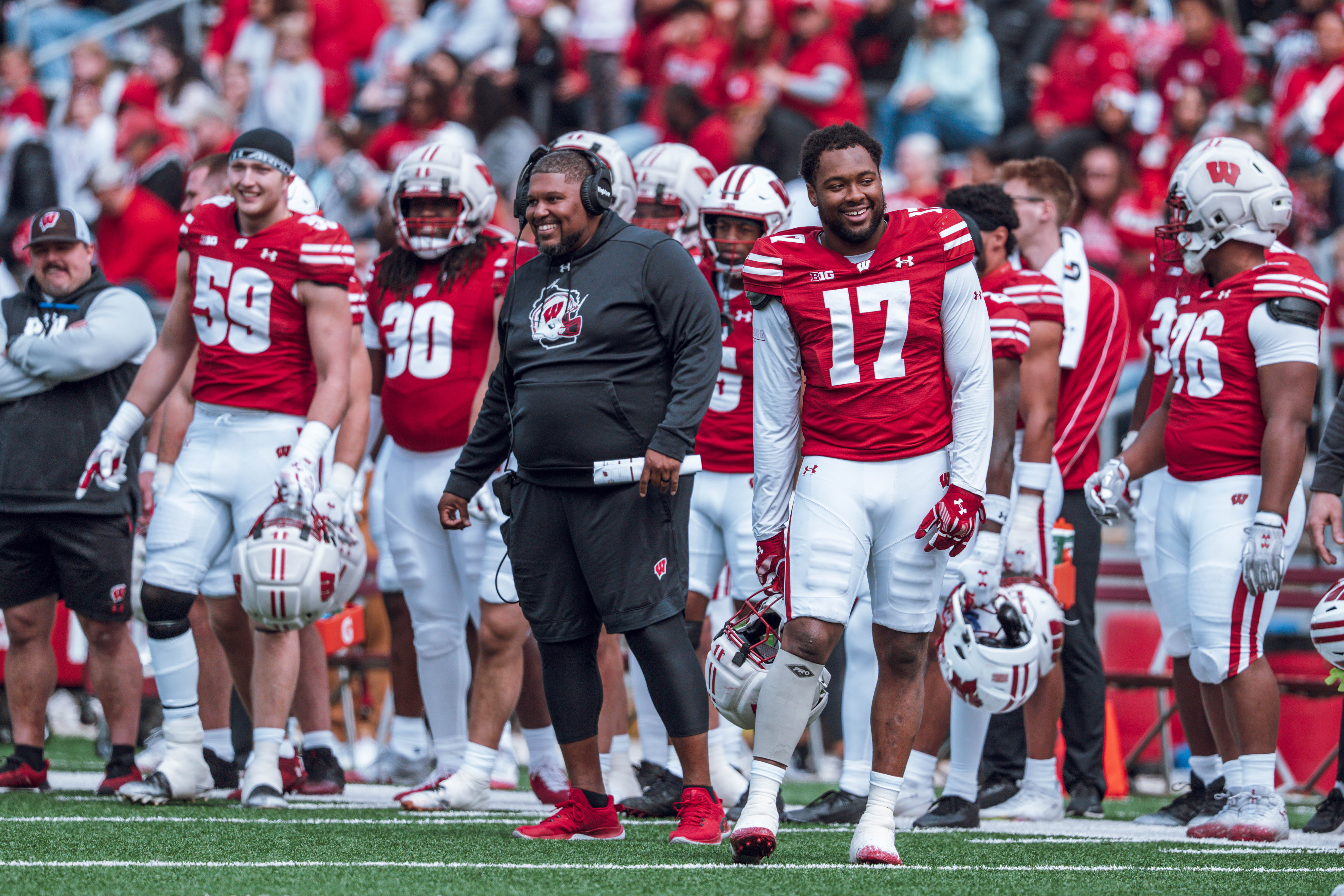 Wisconsin Badgers defensive line coach E.J. Whitlow and outside linebacker Darryl Peterson #17 have chuckle during the Wisconsin Football Spring Showcase at Camp Randall Stadium on April 19, 2025 in Madison, Wisconsin. Photography by Ross Harried for Second Crop Sports.