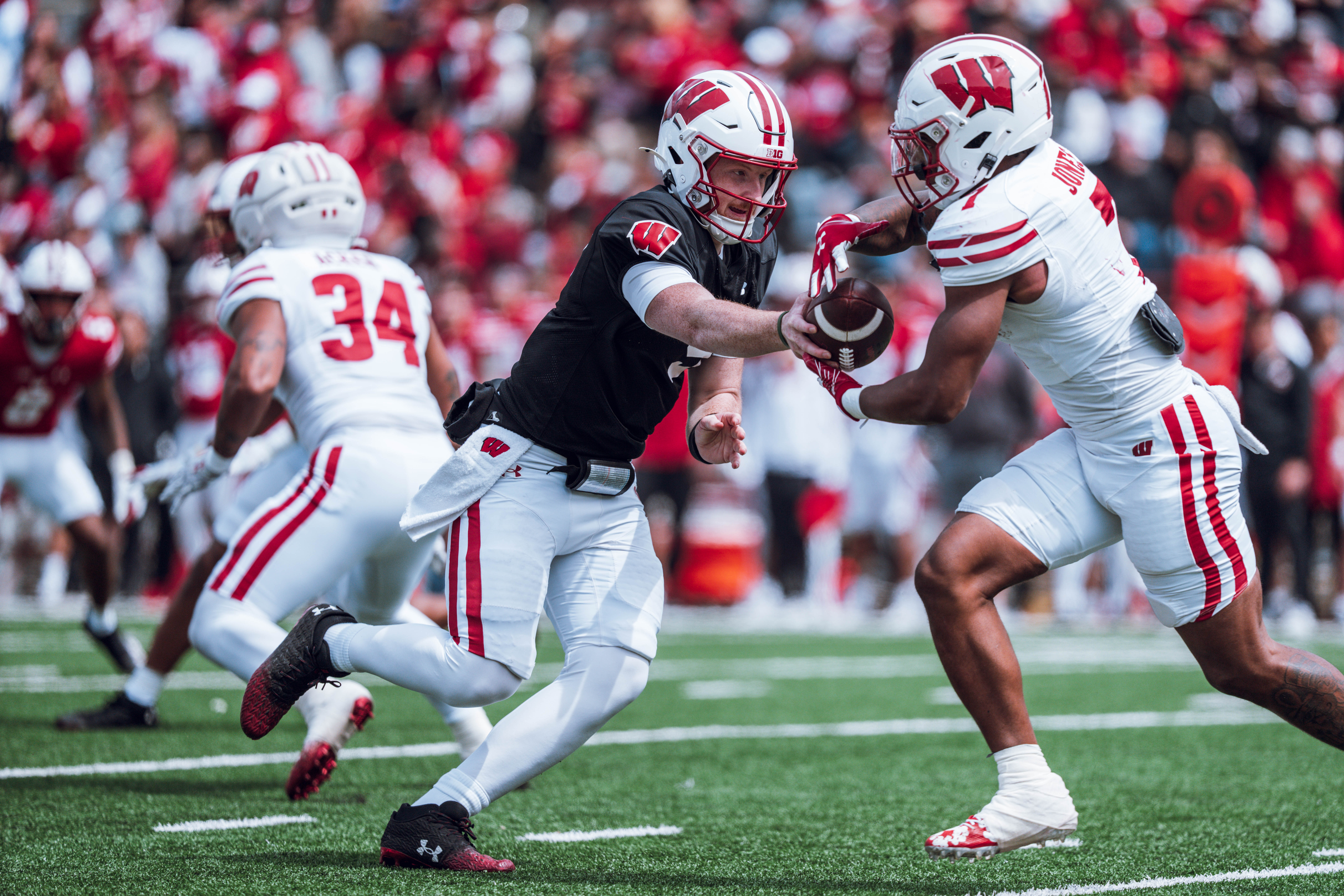 Wisconsin Badgers quarterback Billy Edwards Jr. #9 hands the ball off to running back Dilin Jones #7 during the Wisconsin Football Spring Showcase at Camp Randall Stadium on April 19, 2025 in Madison, Wisconsin. Photography by Ross Harried for Second Crop Sports.