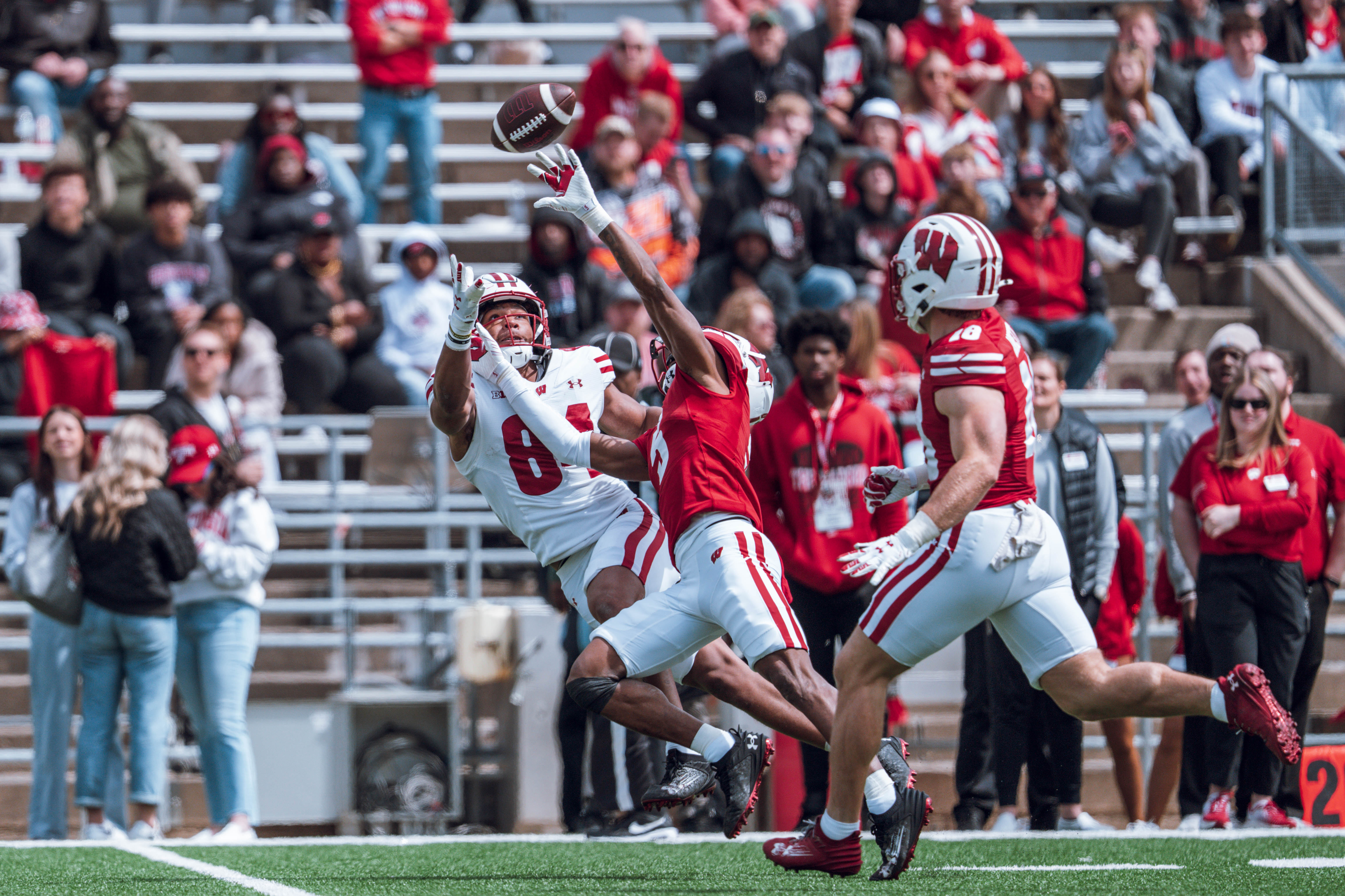 Wisconsin Badgers wide receiver Chris Brooks Jr. #84 attempts to haul in a long pass while defended by Badgers cornerback D'Yoni Hill #5 during the Wisconsin Football Spring Showcase at Camp Randall Stadium on April 19, 2025 in Madison, Wisconsin. Photography by Ross Harried for Second Crop Sports.