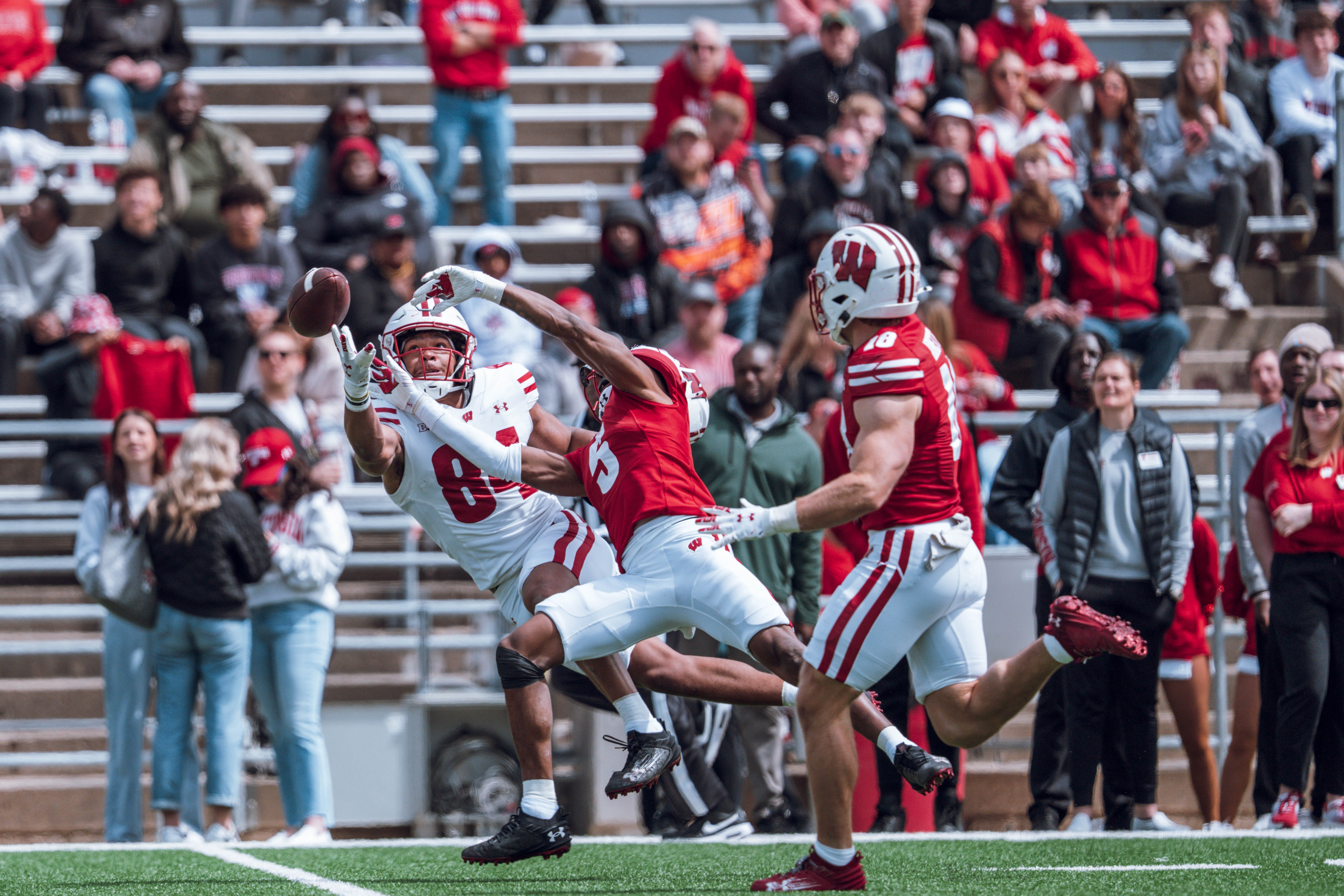 Wisconsin Badgers wide receiver Chris Brooks Jr. #84 attempts to haul in a long pass while defended by Badgers cornerback D'Yoni Hill #5 during the Wisconsin Football Spring Showcase at Camp Randall Stadium on April 19, 2025 in Madison, Wisconsin. Photography by Ross Harried for Second Crop Sports.