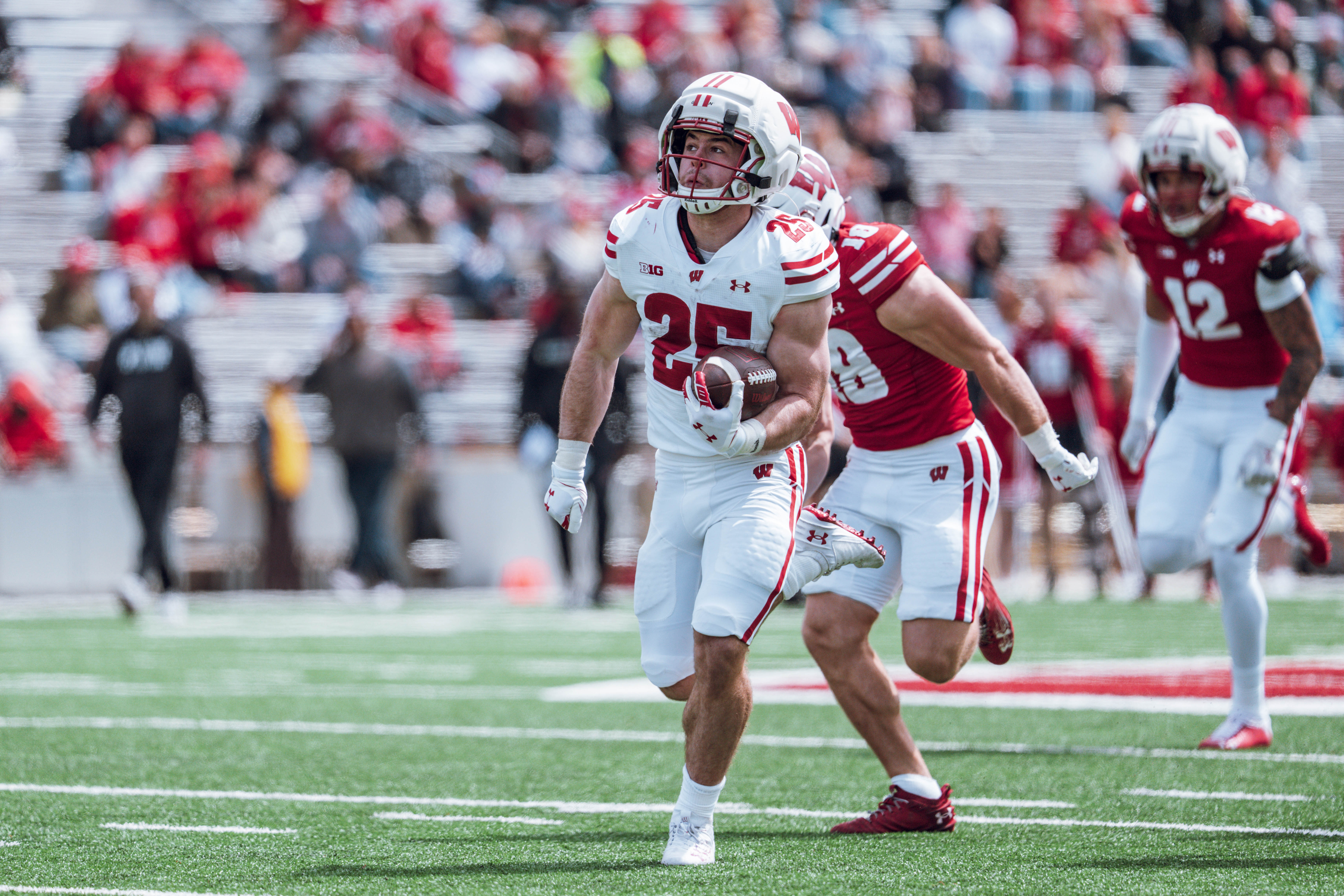 Wisconsin Badgers running back Cade Yacamelli #25 finds the hole during the Wisconsin Football Spring Showcase at Camp Randall Stadium on April 19, 2025 in Madison, Wisconsin. Photography by Ross Harried for Second Crop Sports.