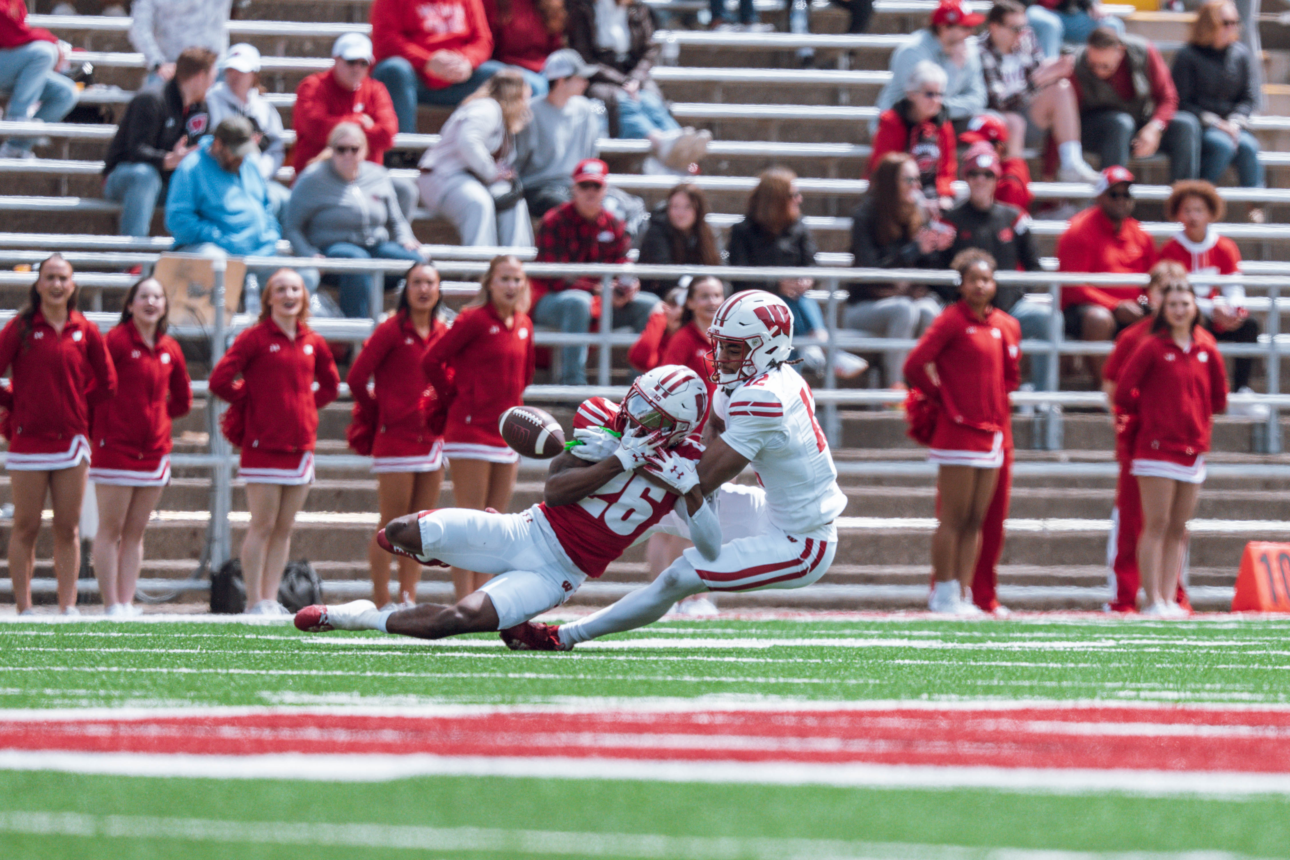 Wisconsin Badgers wide receiver Joseph Griffin Jr. #12 attempts to catch a pass while defended by Badgers cornerback Jay Harper #26 during the Wisconsin Football Spring Showcase at Camp Randall Stadium on April 19, 2025 in Madison, Wisconsin. Photography by Ross Harried for Second Crop Sports.