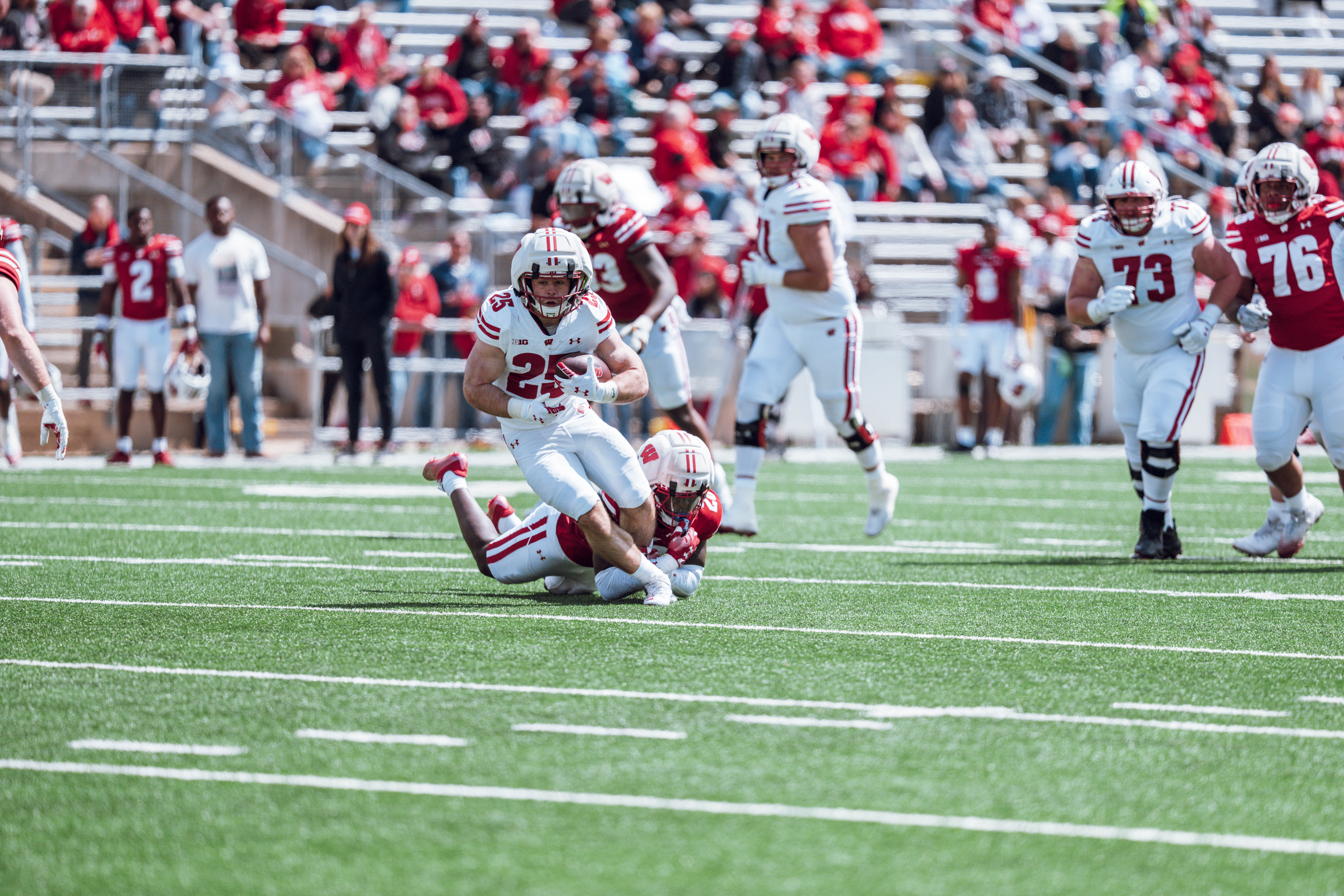 Wisconsin Badgers running back Cade Yacamelli #25 attempts to break an ankle tackle during the Wisconsin Football Spring Showcase at Camp Randall Stadium on April 19, 2025 in Madison, Wisconsin. Photography by Ross Harried for Second Crop Sports.