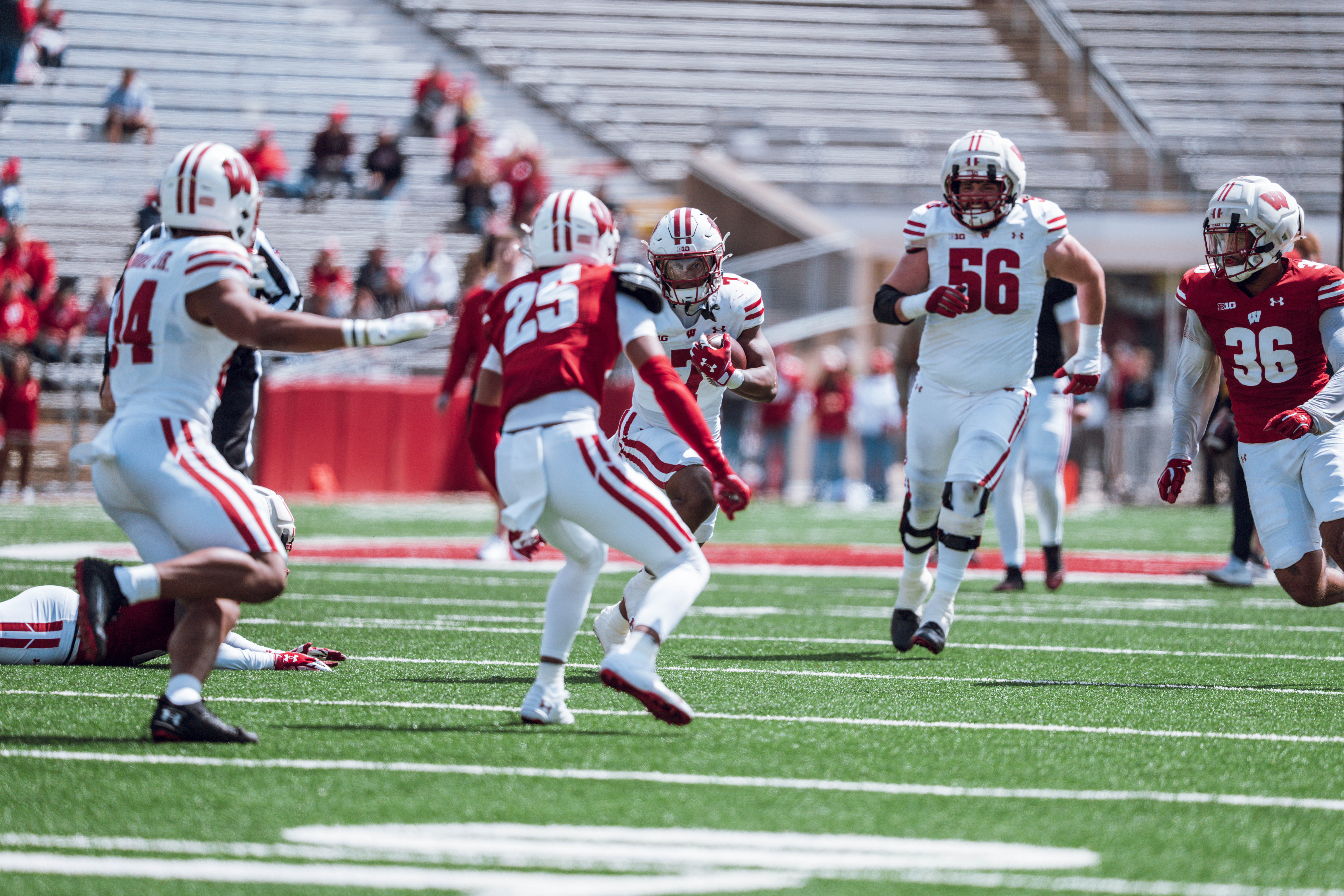 Wisconsin Badgers running back Dilin Jones #7 eyes Badgers cornerback Cairo Skanes #25 during the Wisconsin Football Spring Showcase at Camp Randall Stadium on April 19, 2025 in Madison, Wisconsin. Photography by Ross Harried for Second Crop Sports.