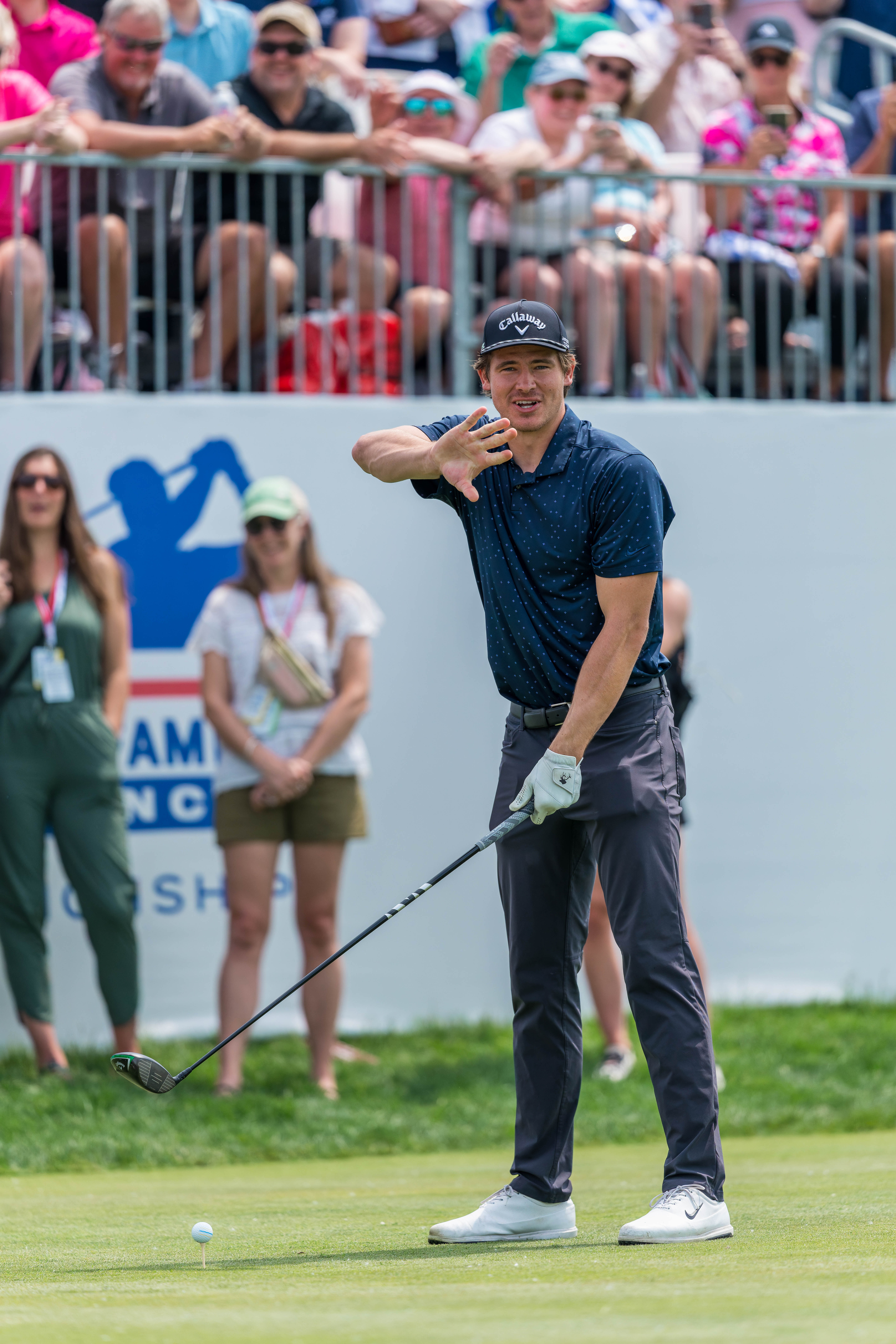 Justin Herbert warns spectators to back up at the tee box on hole 1 during round 2 of The American Family Insurance Championship at TPC Wisconsin in Madison, Wisconsin on June 7th, 2025. Photography by Ross Harried for Second Crop Sports.