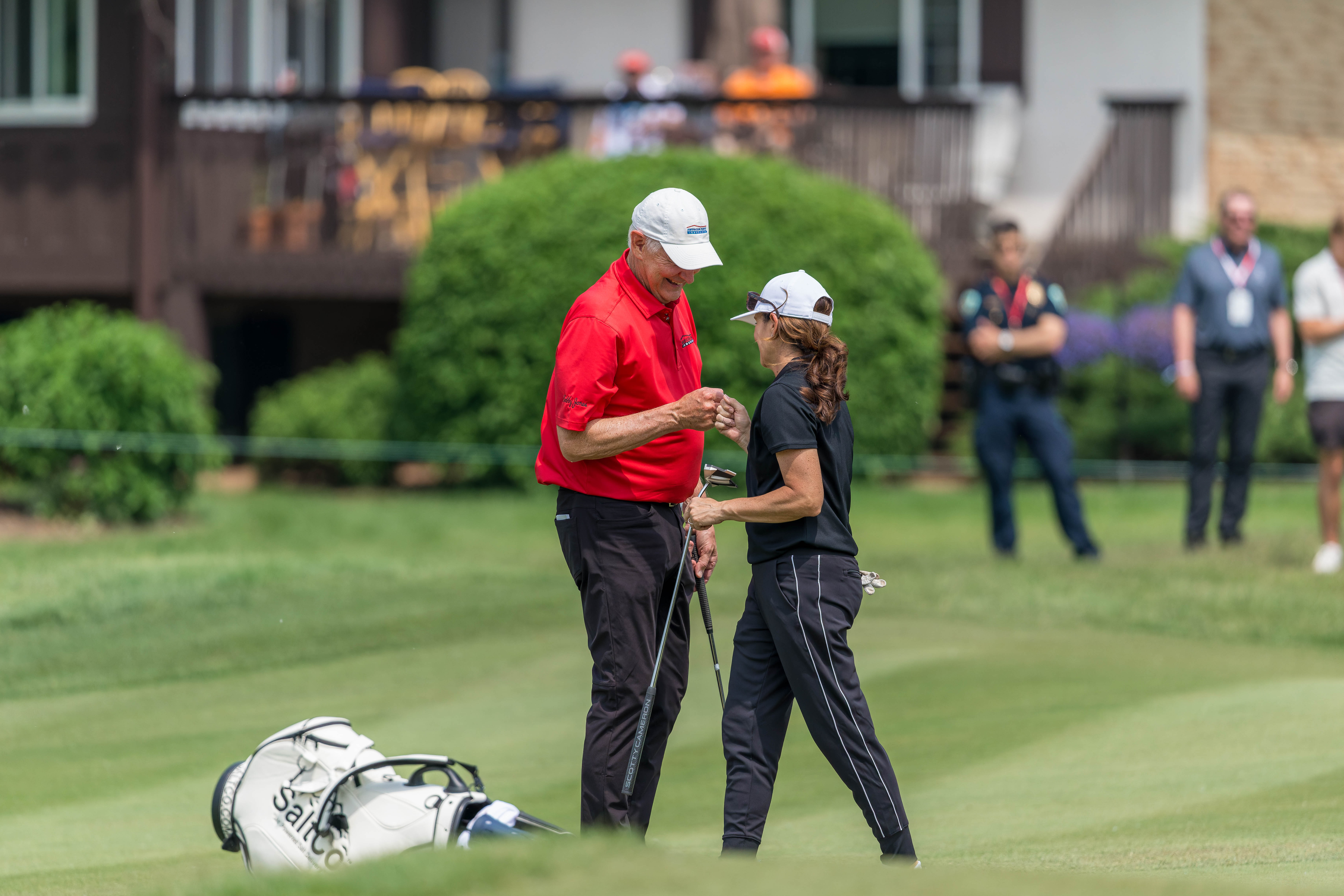 Andy North (left) fist bumps Mia Hamm (right) after hole 11 during round 2 of The American Family Insurance Championship at TPC Wisconsin in Madison, Wisconsin on June 7th, 2025. Photography by Ross Harried for Second Crop Sports.