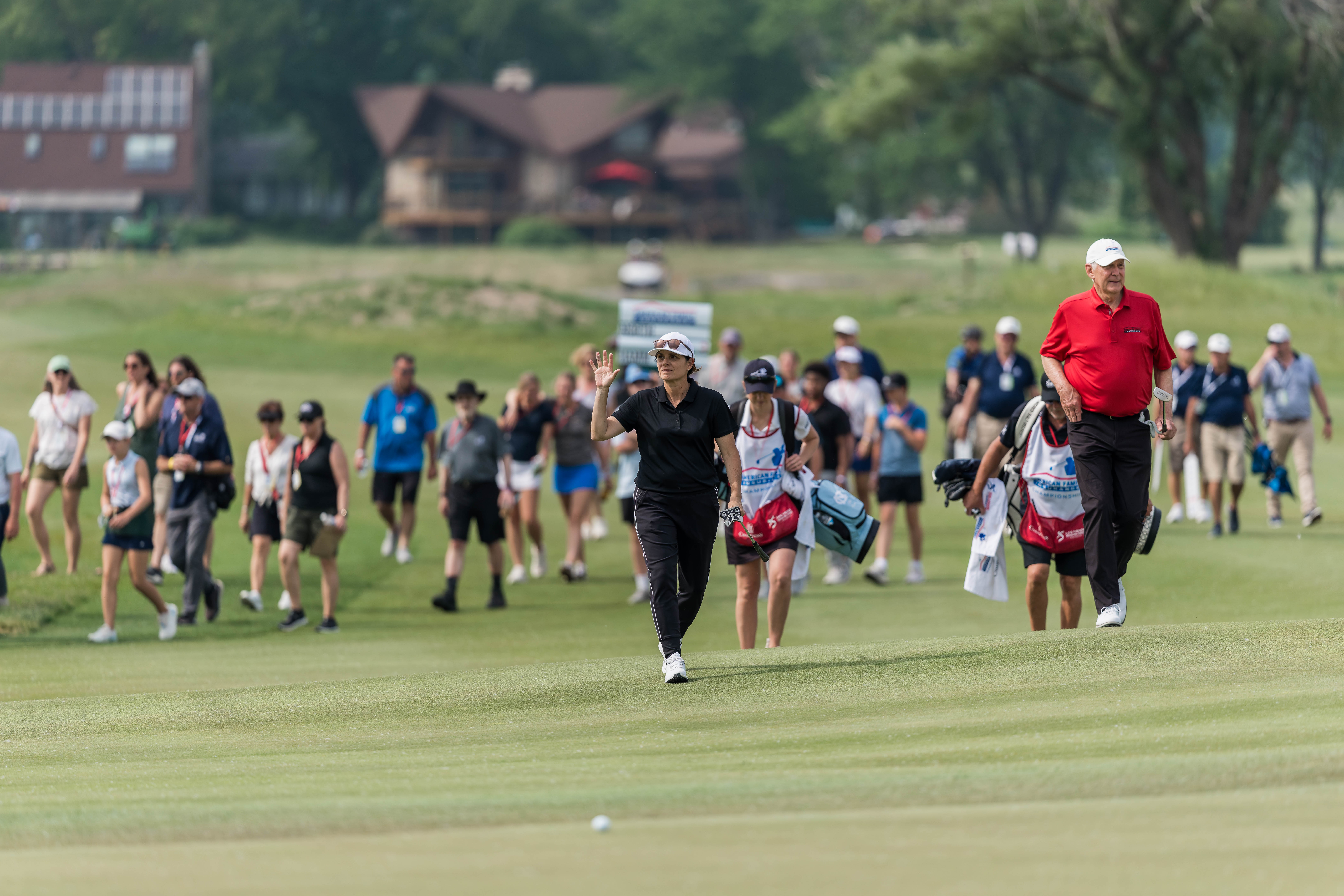 Mia Hamm waves to the crowd as she heads the green on hole 18 during round 2 of The American Family Insurance Championship at TPC Wisconsin in Madison, Wisconsin on June 7th, 2025. Photography by Ross Harried for Second Crop Sports.