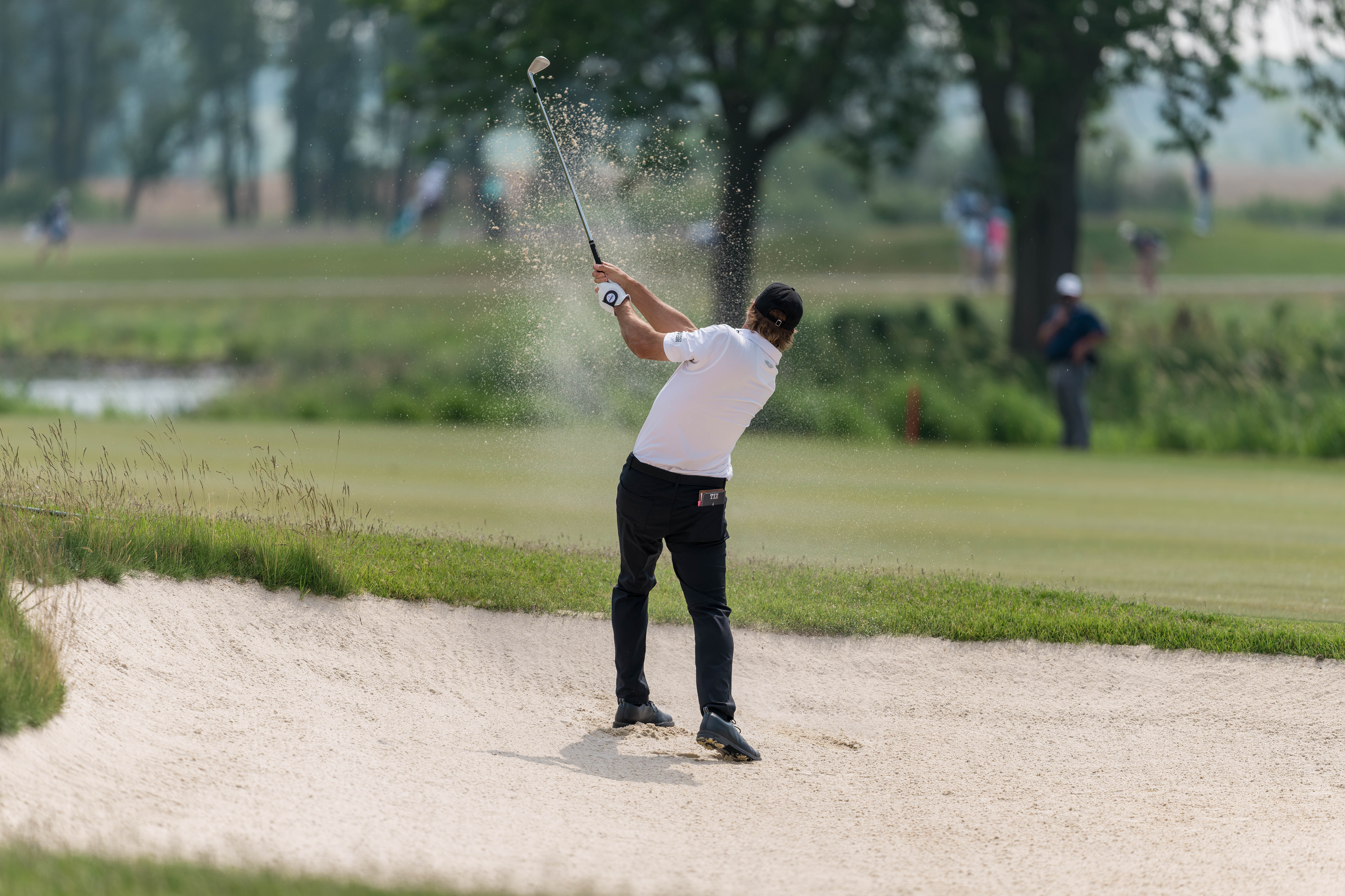 Mario Tiziani hits a shot from a bunker on hole 2 during round 3 of The American Family Insurance Championship at TPC Wisconsin in Madison, Wisconsin on June 8th, 2025. Photography by Ross Harried for Second Crop Sports.