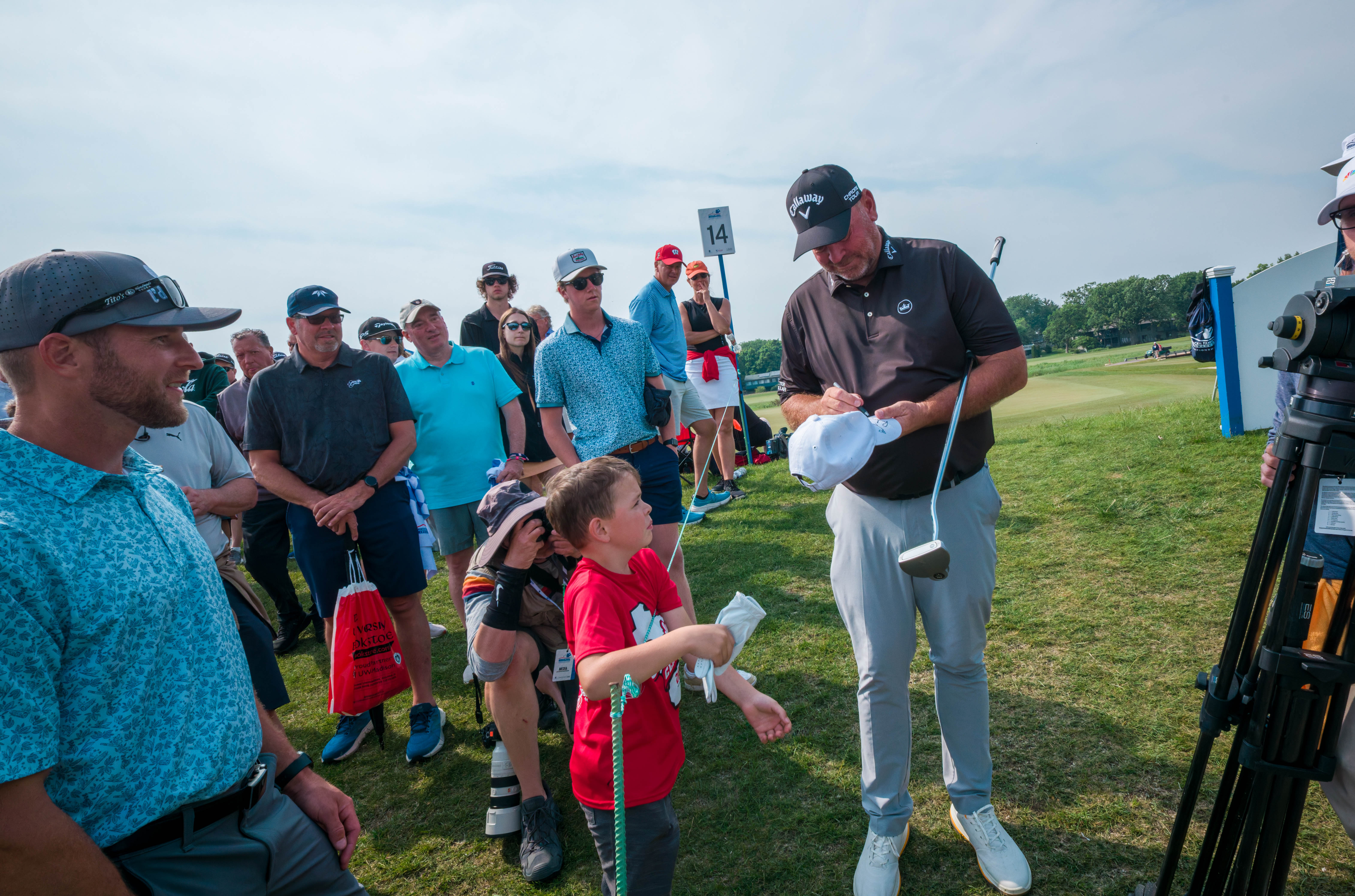 Thomas Bjørn signs a hat for a young fan after finishing hole 14 during round 3 of The American Family Insurance Championship at TPC Wisconsin in Madison, Wisconsin on June 8th, 2025. Photography by Ross Harried for Second Crop Sports.
