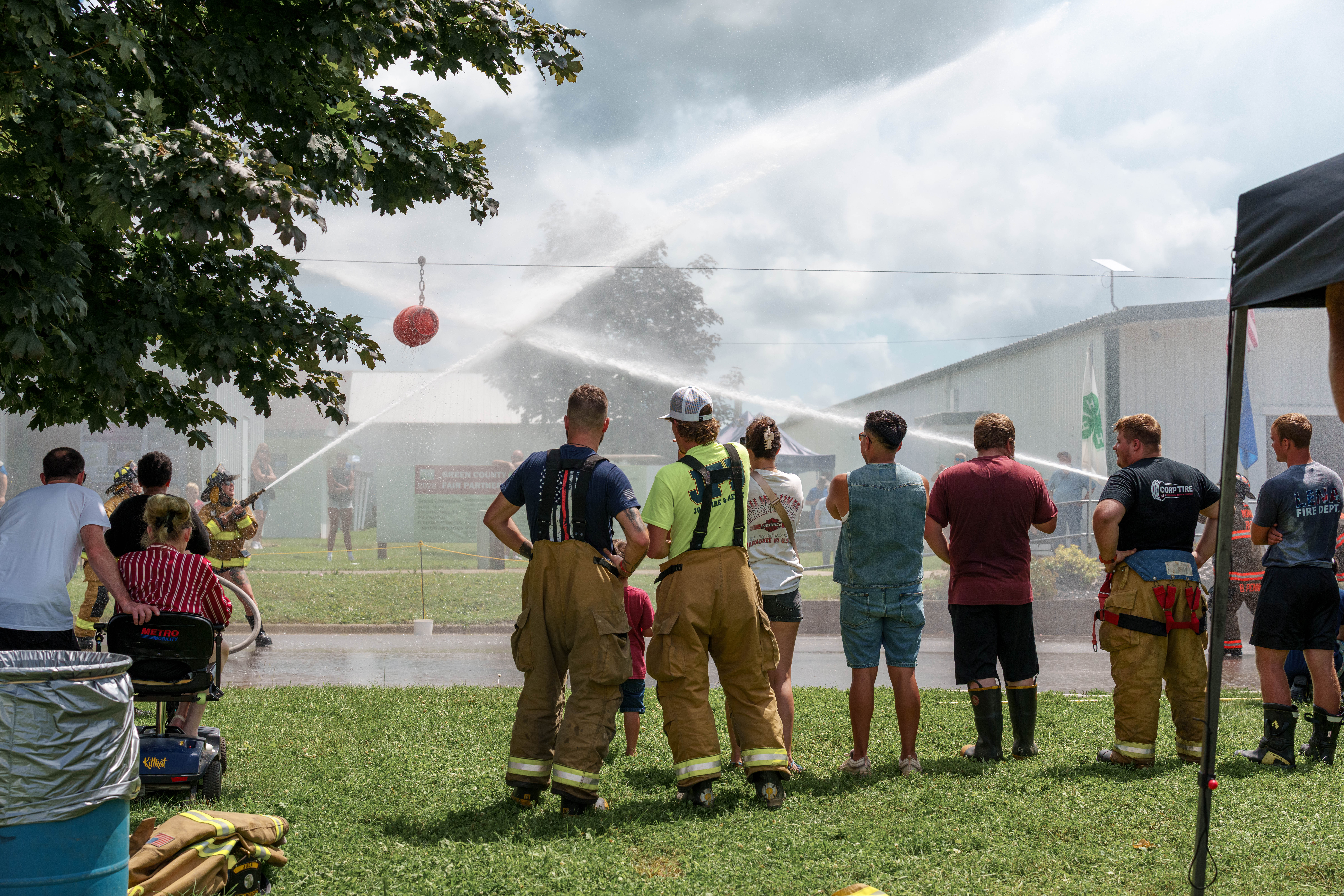 Firefighter water fight at the Green County Fair in Monroe, Wisconsin on July 19th, 2025. Photography by Ross Harried for Second Crop Sports.