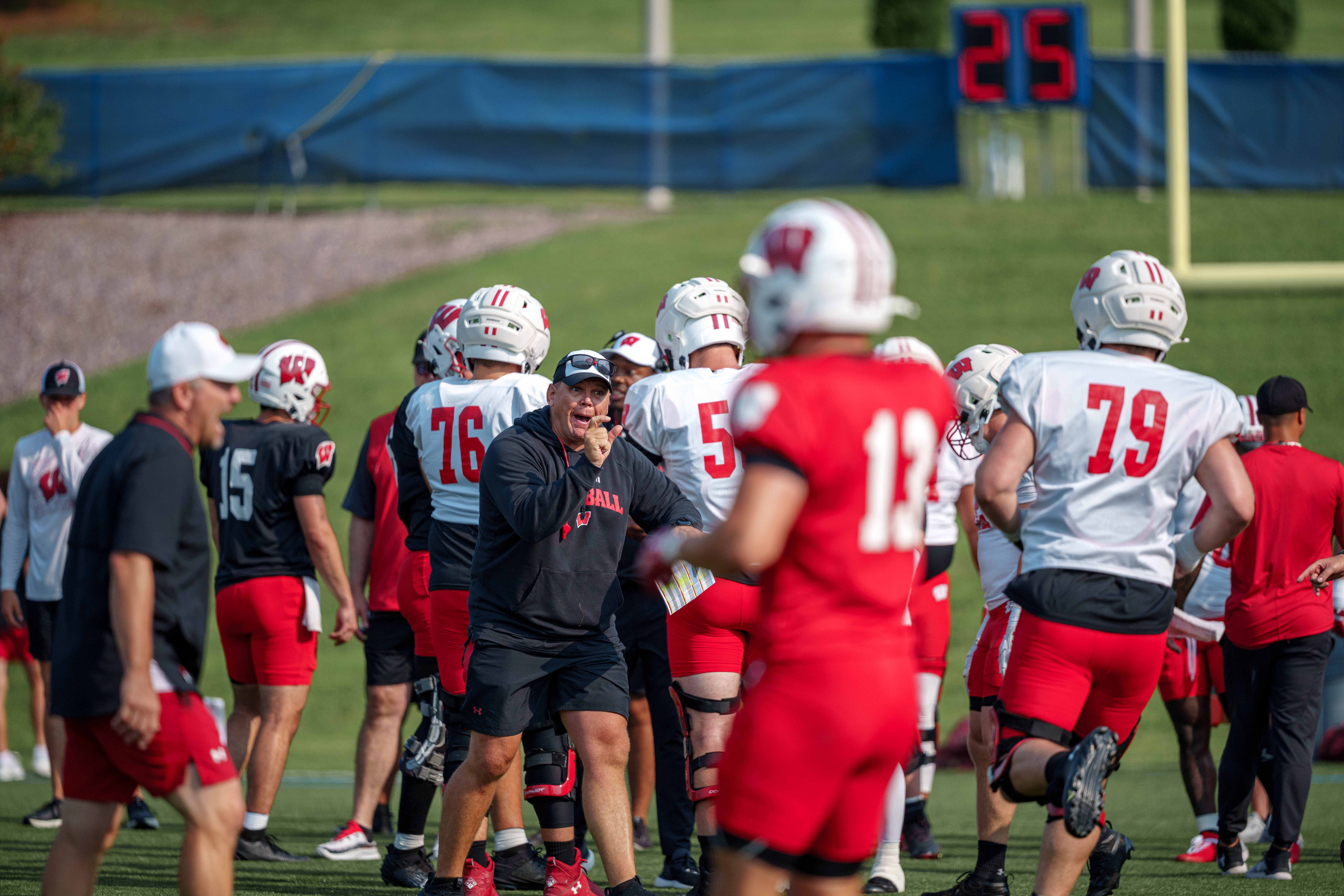 Wisconsin offensive line coach AJ Blazek makes a hand gesture during training camp at Ralph E. Davis Pioneer Stadium on August 03, 2025 in Platteville, Wisconsin. Photography by Ross Harried for Second Crop Sports.
