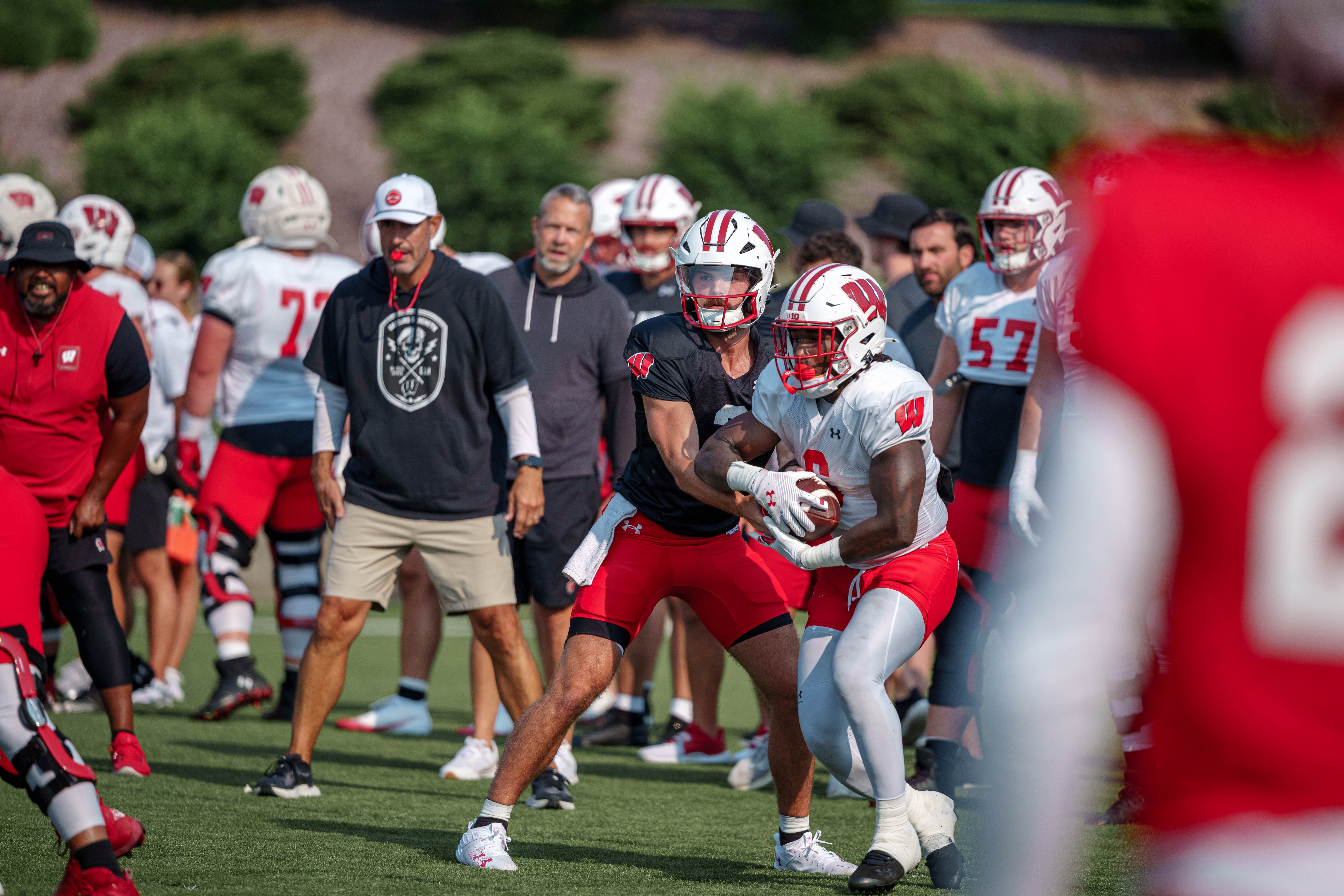 Wisconsin Badgers quarterback Carter Smith (3) hands the ball off to running back Darrion Dupree (6) during training camp at Ralph E. Davis Pioneer Stadium on August 03, 2025 in Platteville, Wisconsin. Photography by Ross Harried for Second Crop Sports.