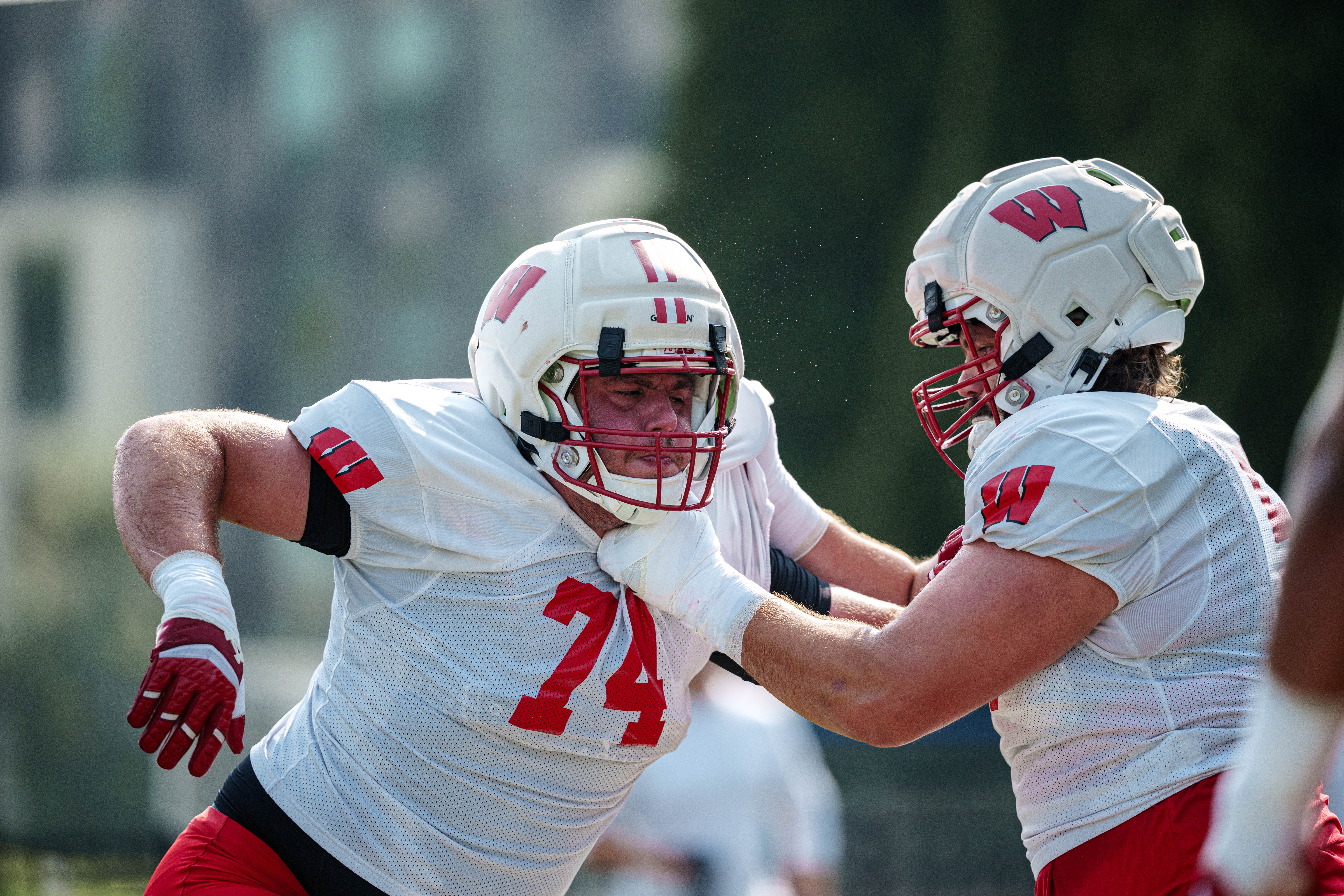 Wisconsin Badgers offensive lineman Davis Heinzen (74) does a blocking drill during training camp at Ralph E. Davis Pioneer Stadium on August 03, 2025 in Platteville, Wisconsin. Photography by Ross Harried for Second Crop Sports.