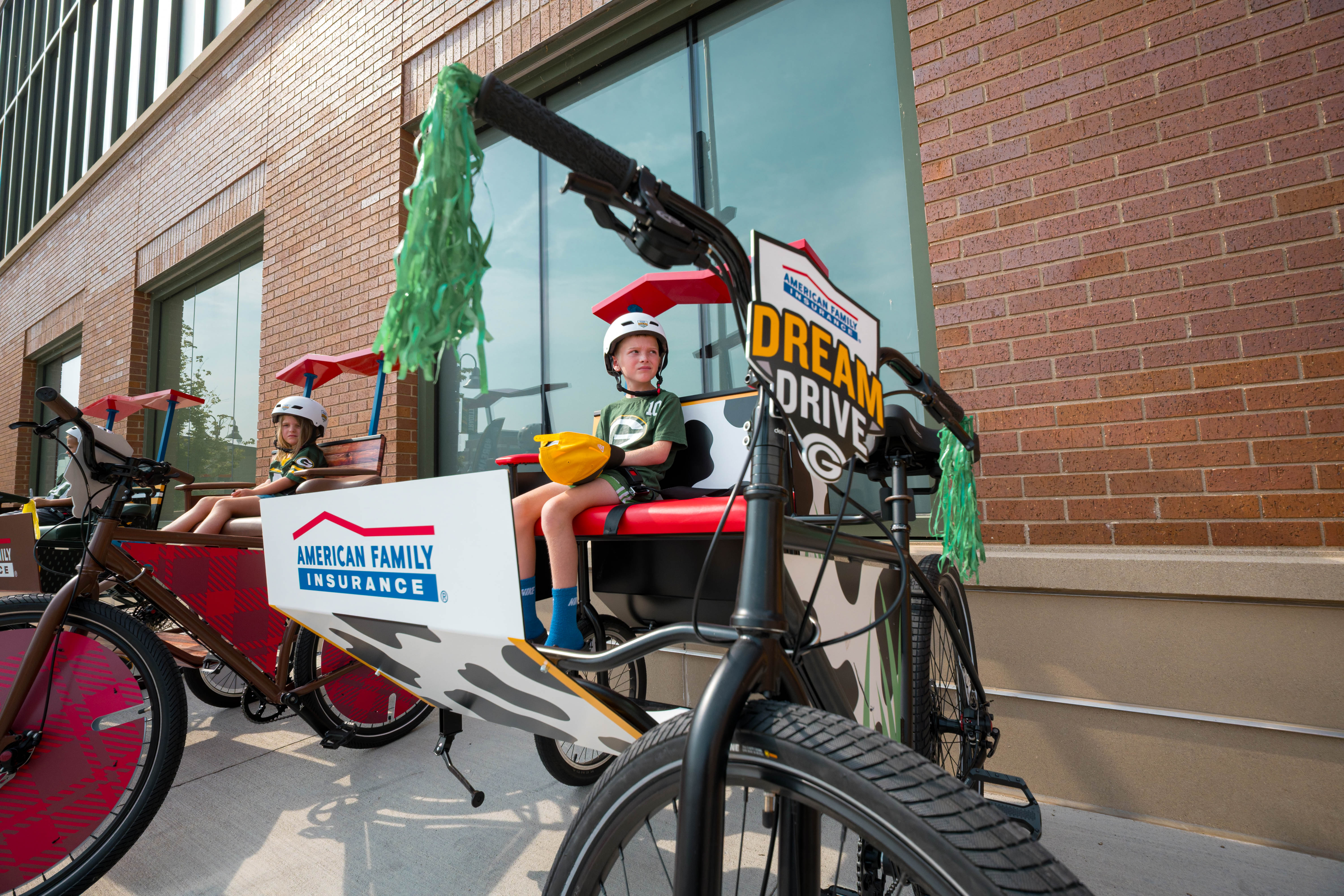 Children sit in themed bicycles as part of the Green Bay Packers’ DreamDrive tradition before training camp practice in Green Bay, Wisconsin, on August 6th, 2025. Photography by Ross Harried for Second Crop Sports.