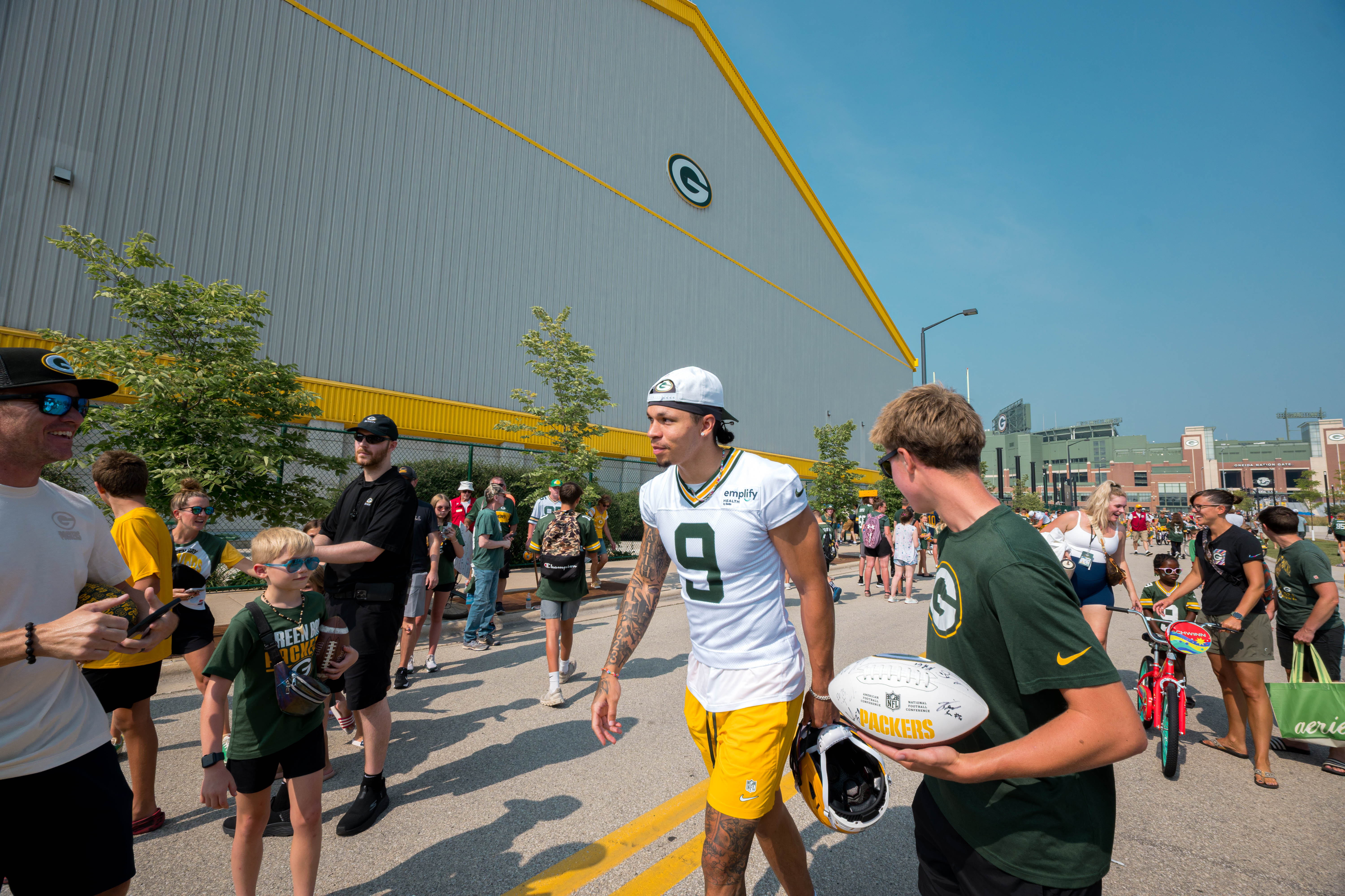 Green Bay Packers wide receiver Christian Watson walks past fans on his way to practice during training camp at Ray Nitschke Field in Green Bay, Wisconsin, on August 6th, 2025. Photography by Ross Harried for Second Crop Sports.