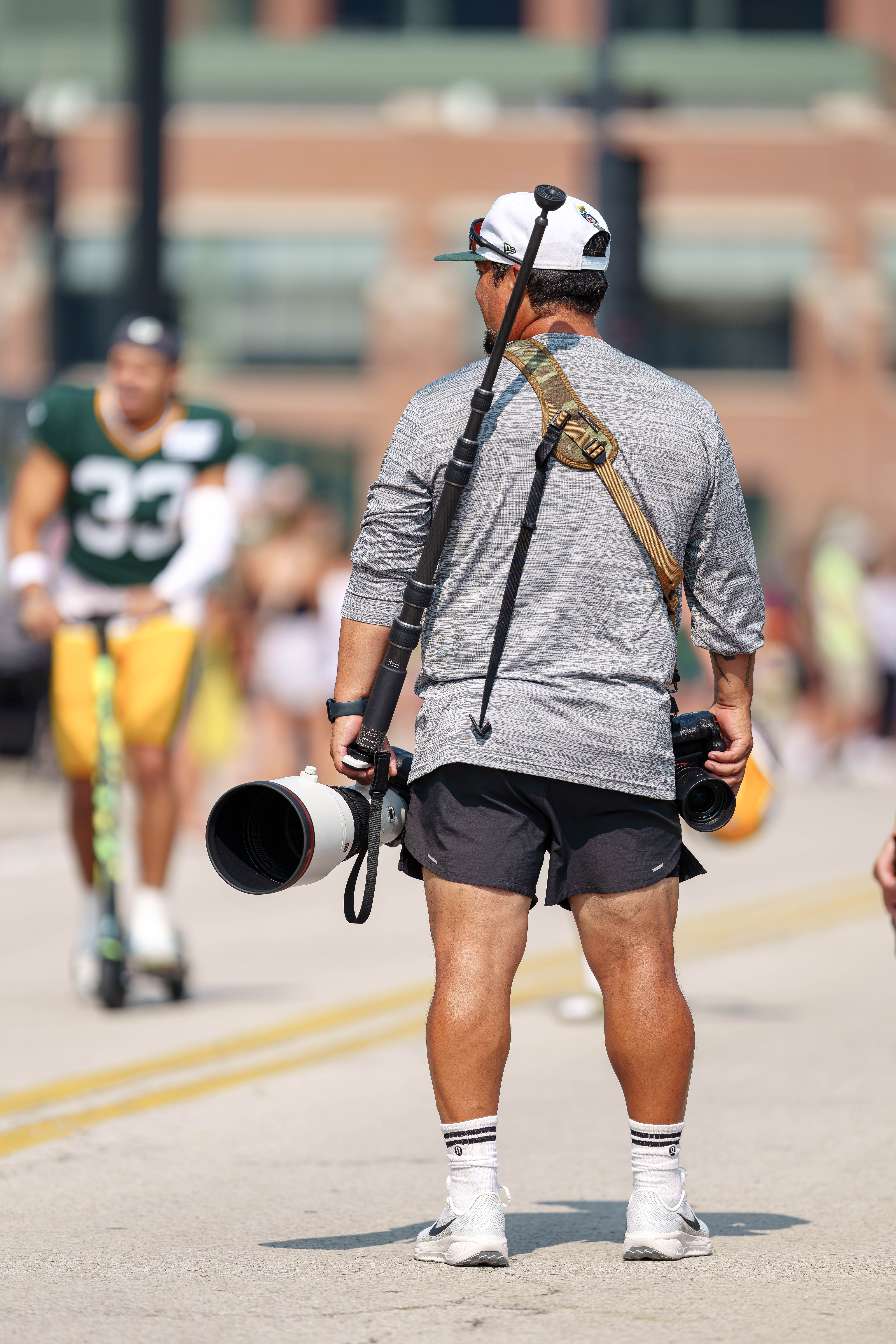 Green Bay Packers team photographer Evan Siegle carries camera equipment during the team’s DreamDrive tradition at training camp in Green Bay, Wisconsin, on August 6th, 2025. Photography by Ross Harried for Second Crop Sports.