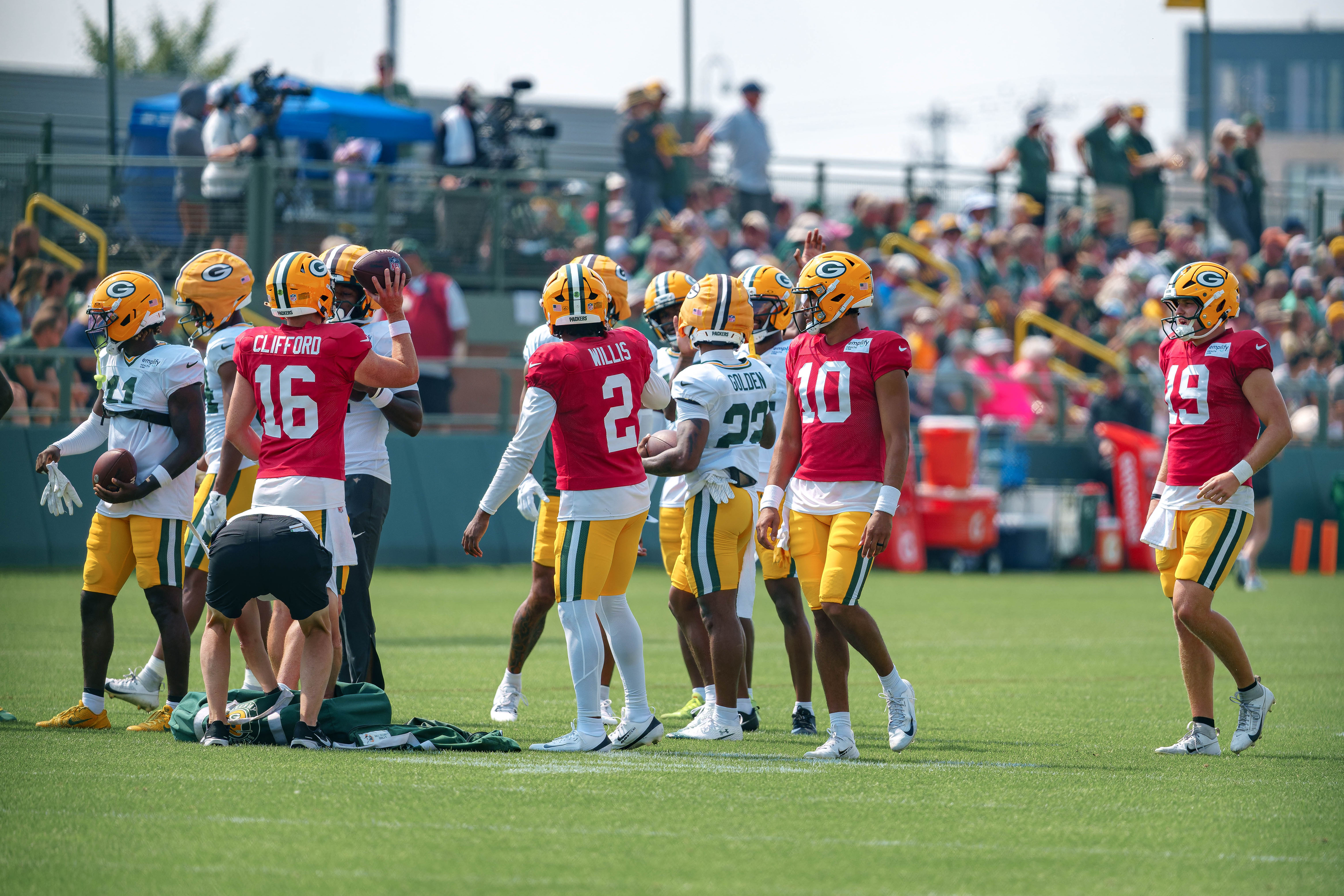 Green Bay Packers quarterbacks, including Sean Clifford (16), Malik Willis (2), Jordan Love (10) and Taylor Elgersma (19) gather during training camp at Ray Nitschke Field in Green Bay, Wisconsin, on August 6th, 2025. Photography by Ross Harried for Second Crop Sports.