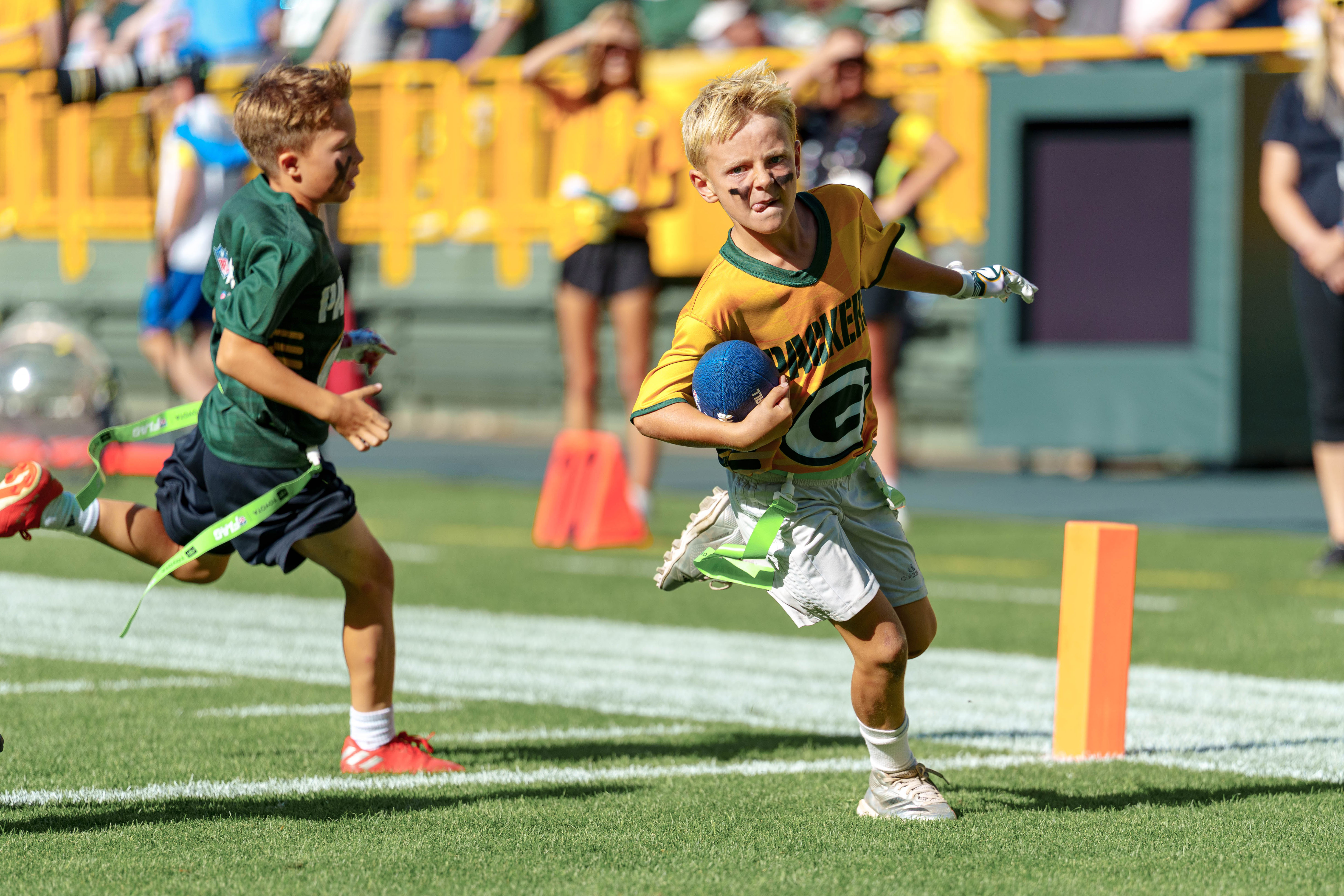 The Verona Area flag football team takes the field during halftime of an NFL preseason game between the Green Bay Packers and Seattle Seahawks at Lambeau Field in Green Bay, Wisconsin, on August 23, 2025. Photography by Ross Harried for Second Crop Sports.