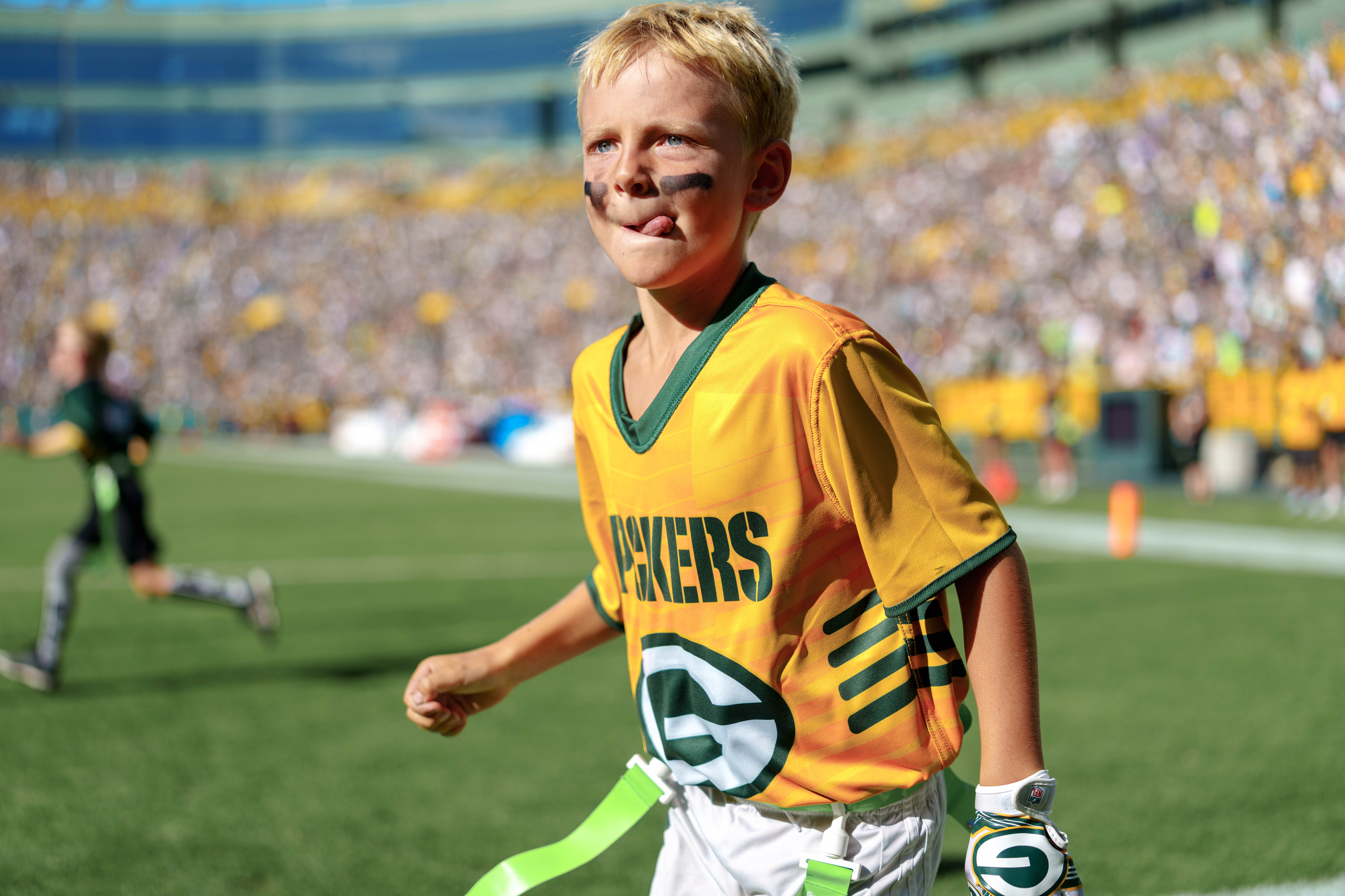 The Verona Area flag football team takes the field during halftime of an NFL preseason game between the Green Bay Packers and Seattle Seahawks at Lambeau Field in Green Bay, Wisconsin, on August 23, 2025. Photography by Ross Harried for Second Crop Sports.