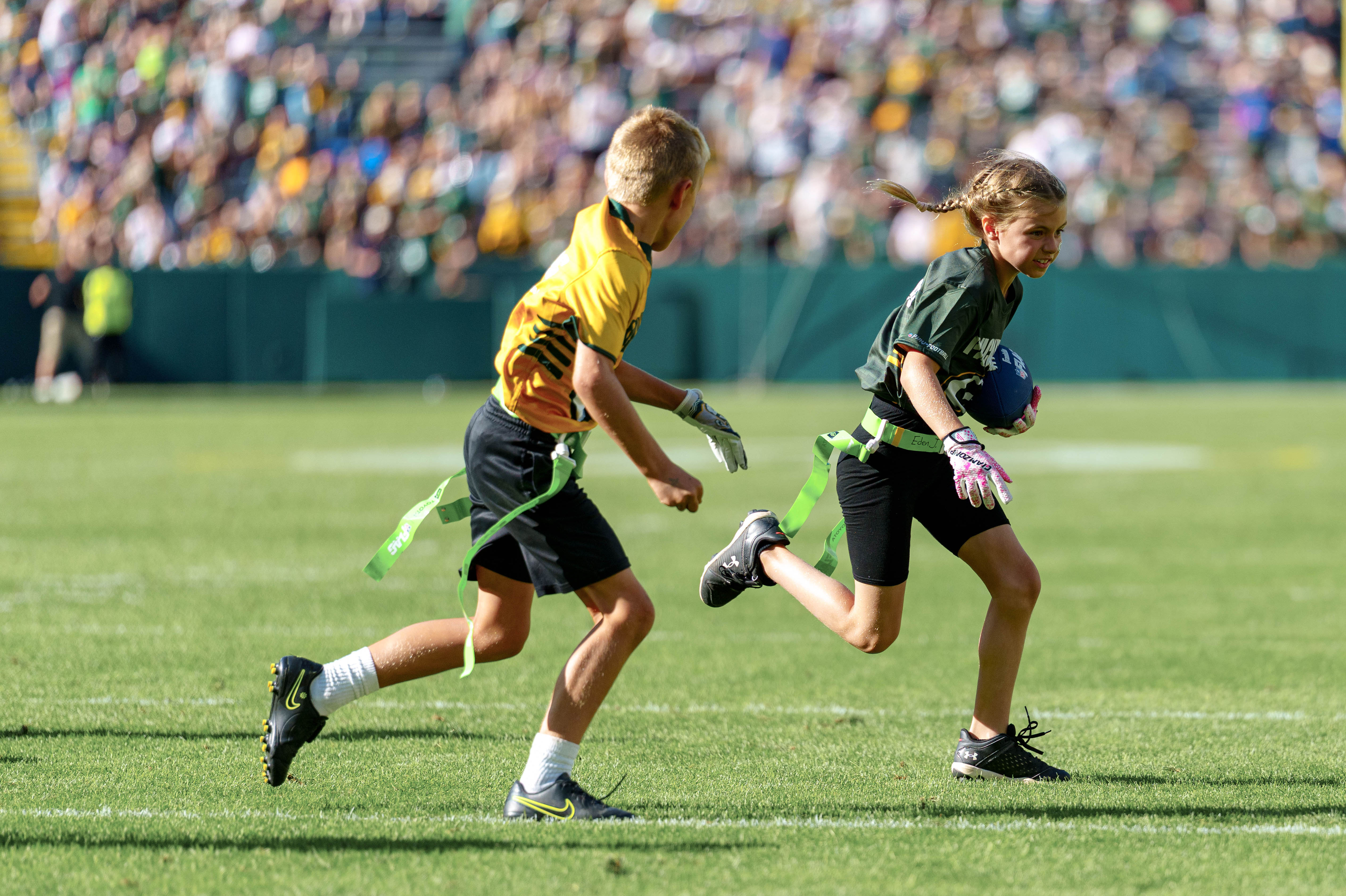 The Verona Area flag football team takes the field during halftime of an NFL preseason game between the Green Bay Packers and Seattle Seahawks at Lambeau Field in Green Bay, Wisconsin, on August 23, 2025. Photography by Ross Harried for Second Crop Sports.