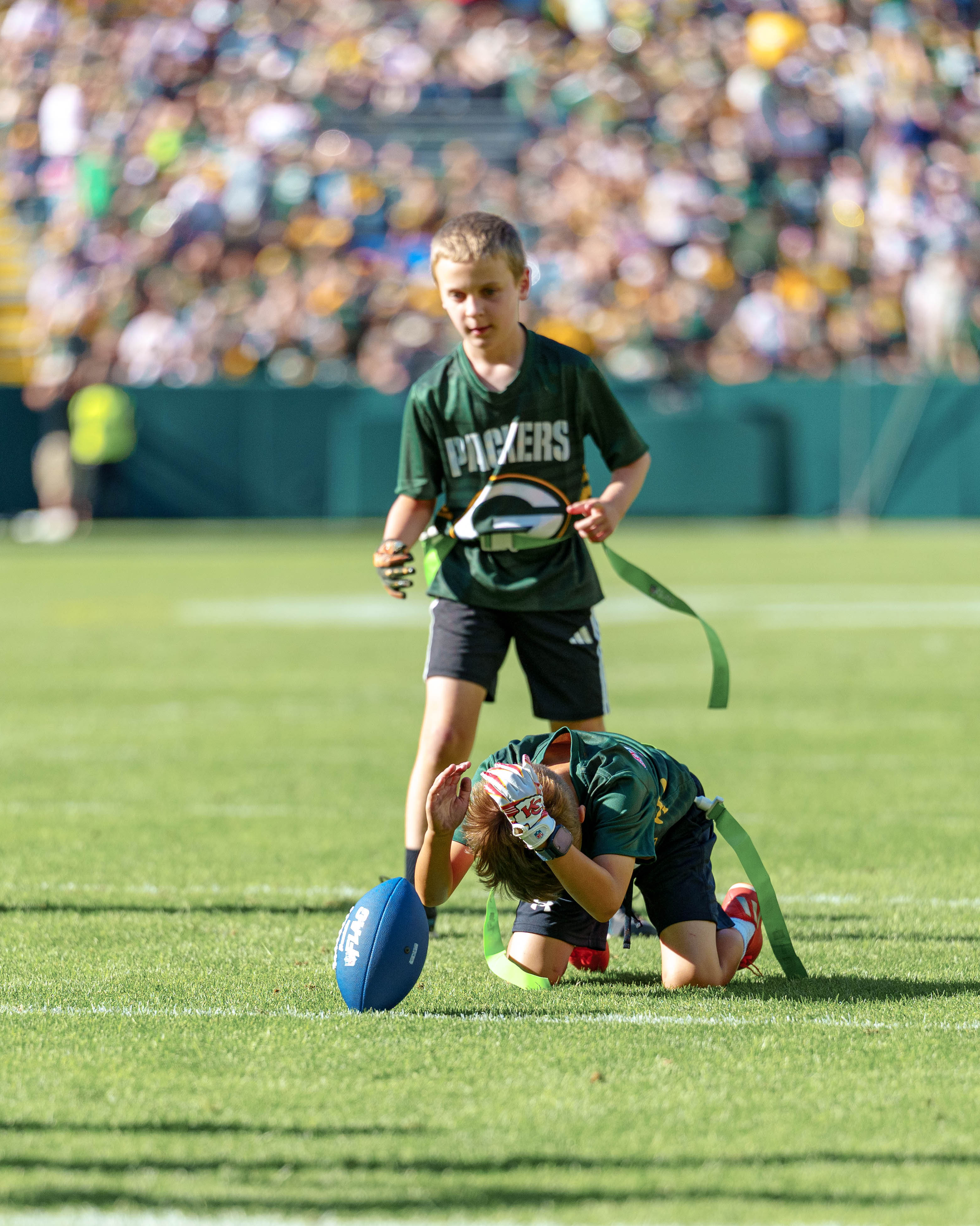 The Verona Area flag football team takes the field during halftime of an NFL preseason game between the Green Bay Packers and Seattle Seahawks at Lambeau Field in Green Bay, Wisconsin, on August 23, 2025. Photography by Ross Harried for Second Crop Sports.