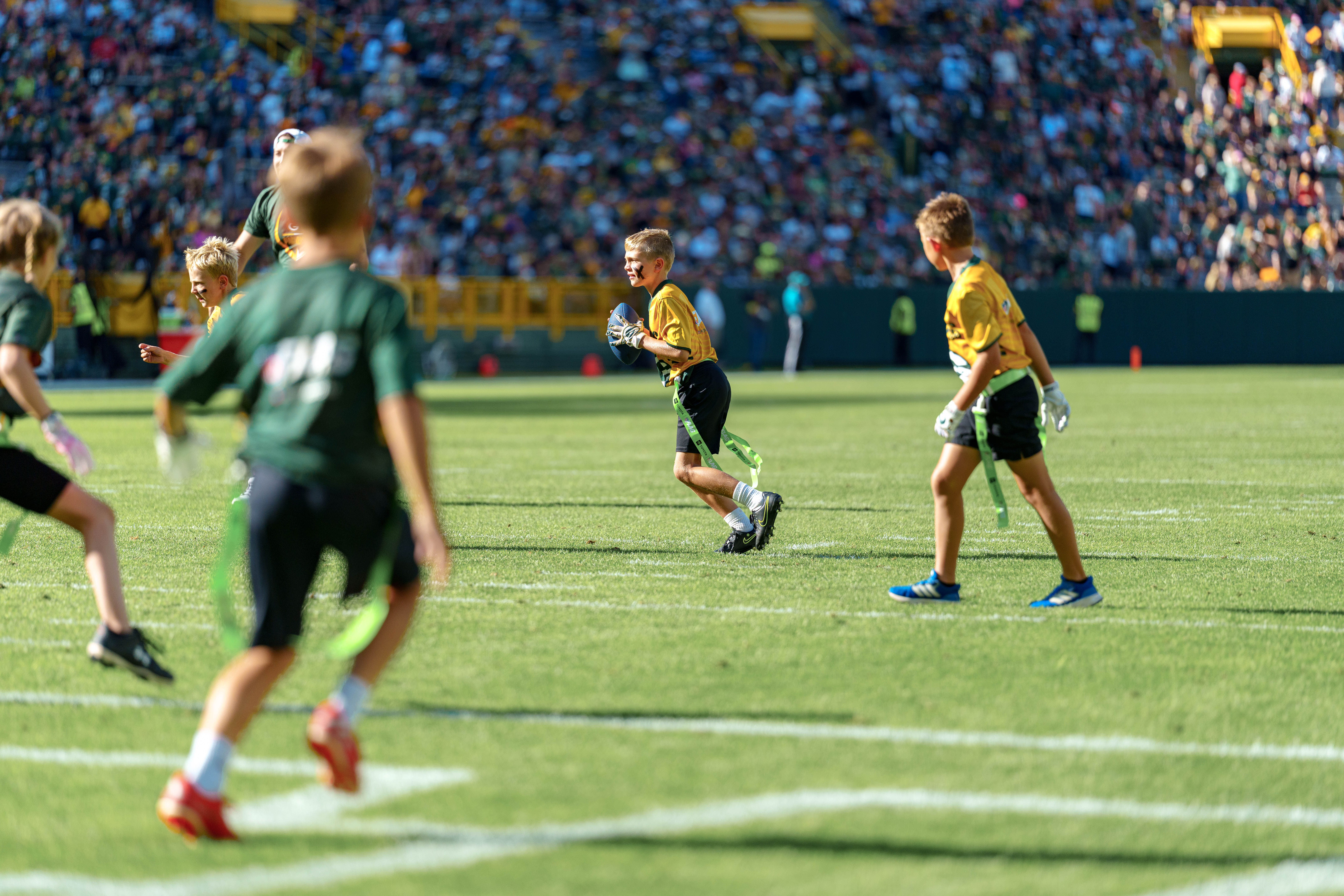 The Verona Area flag football team takes the field during halftime of an NFL preseason game between the Green Bay Packers and Seattle Seahawks at Lambeau Field in Green Bay, Wisconsin, on August 23, 2025. Photography by Ross Harried for Second Crop Sports.