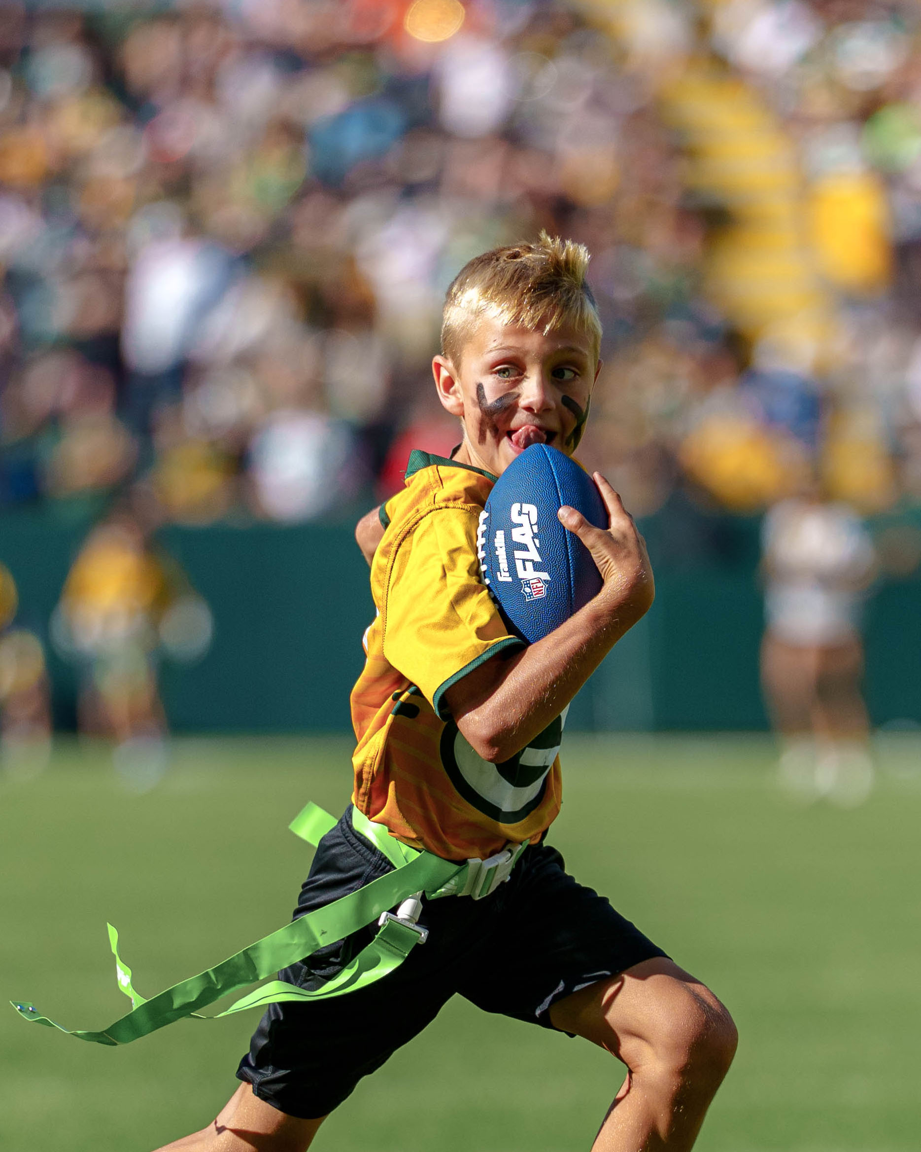 The Verona Area flag football team takes the field during halftime of an NFL preseason game between the Green Bay Packers and Seattle Seahawks at Lambeau Field in Green Bay, Wisconsin, on August 23, 2025. Photography by Ross Harried for Second Crop Sports.
