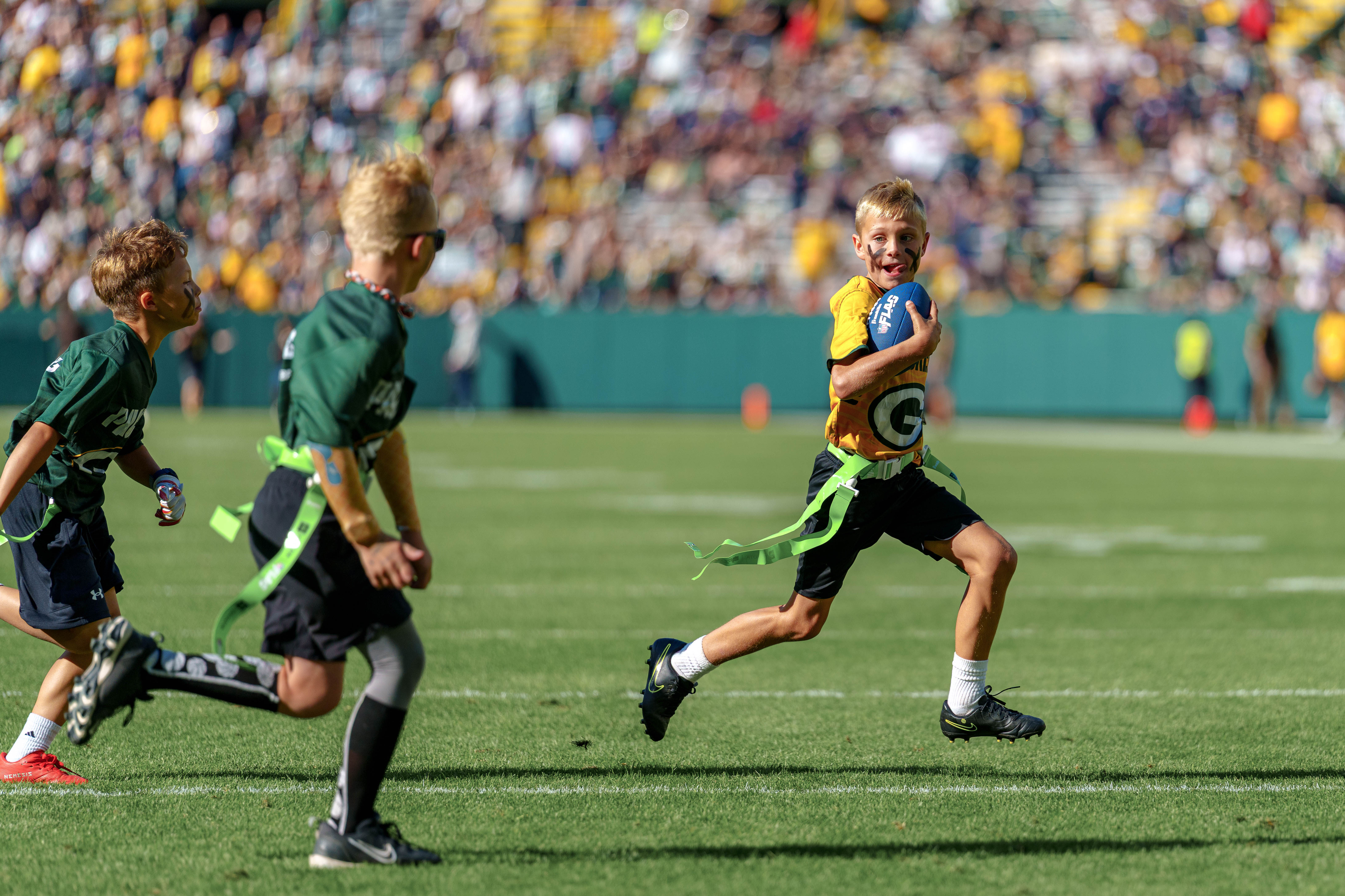 The Verona Area flag football team takes the field during halftime of an NFL preseason game between the Green Bay Packers and Seattle Seahawks at Lambeau Field in Green Bay, Wisconsin, on August 23, 2025. Photography by Ross Harried for Second Crop Sports.