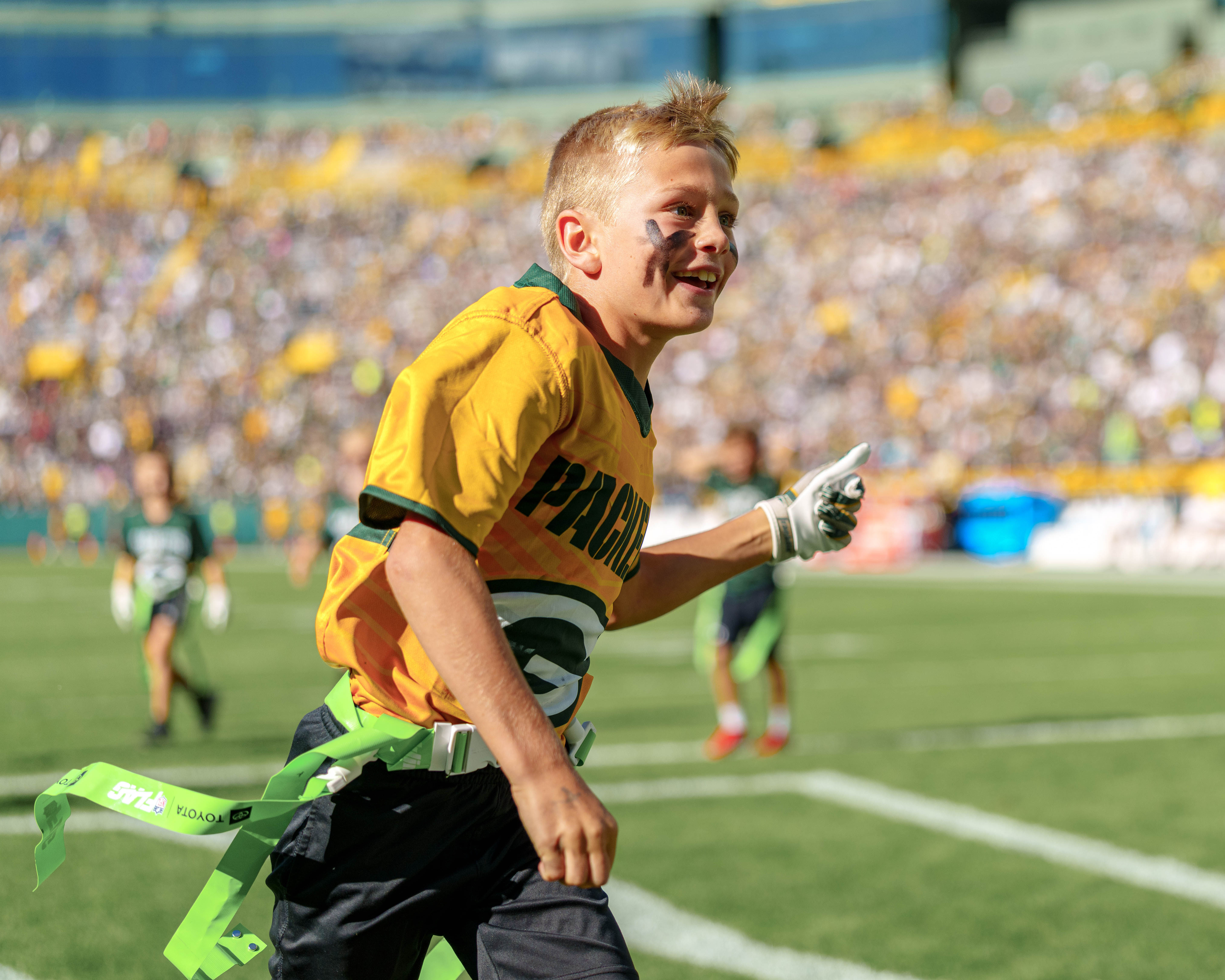 The Verona Area flag football team takes the field during halftime of an NFL preseason game between the Green Bay Packers and Seattle Seahawks at Lambeau Field in Green Bay, Wisconsin, on August 23, 2025. Photography by Ross Harried for Second Crop Sports.