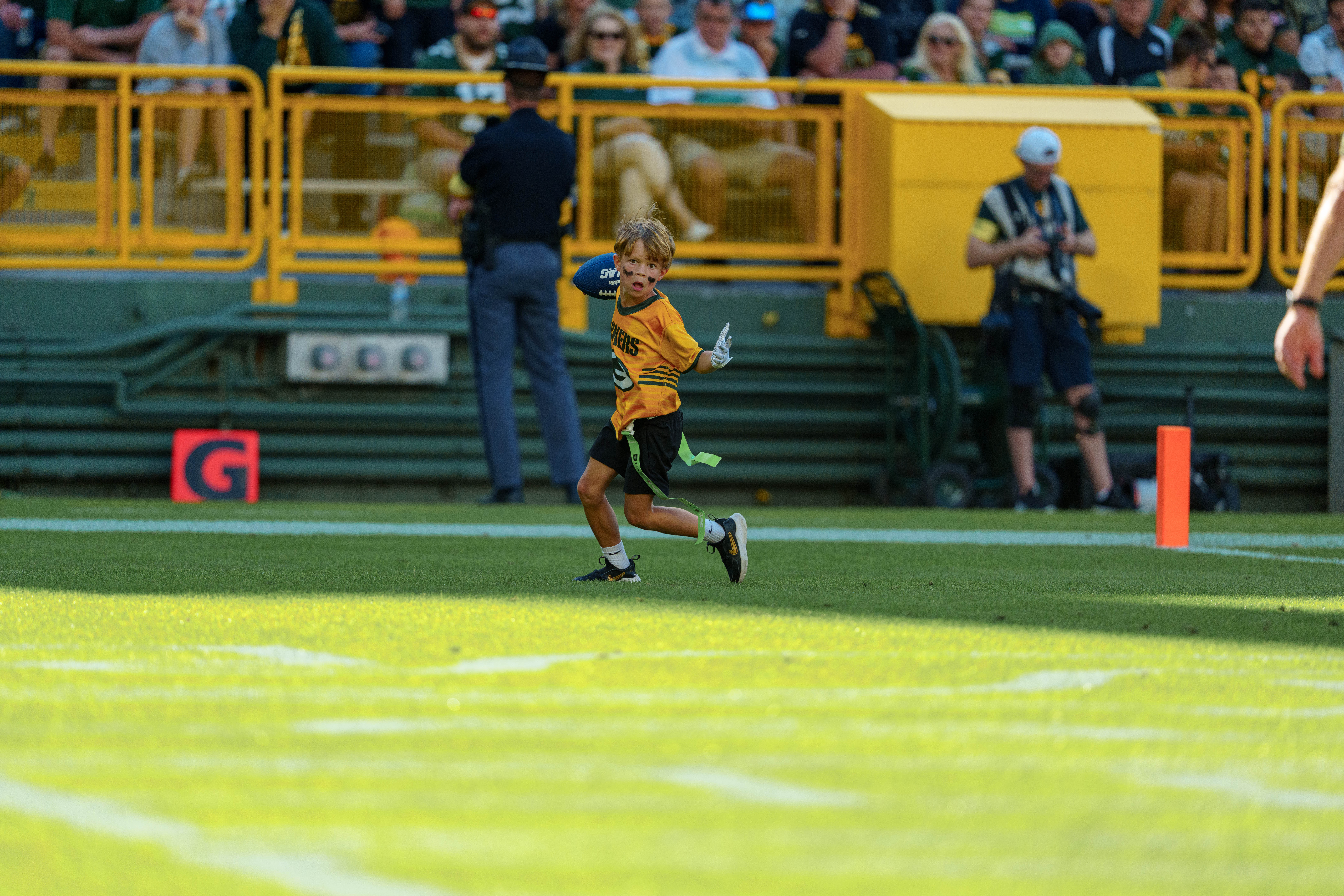 The Verona Area flag football team takes the field during halftime of an NFL preseason game between the Green Bay Packers and Seattle Seahawks at Lambeau Field in Green Bay, Wisconsin, on August 23, 2025. Photography by Ross Harried for Second Crop Sports.
