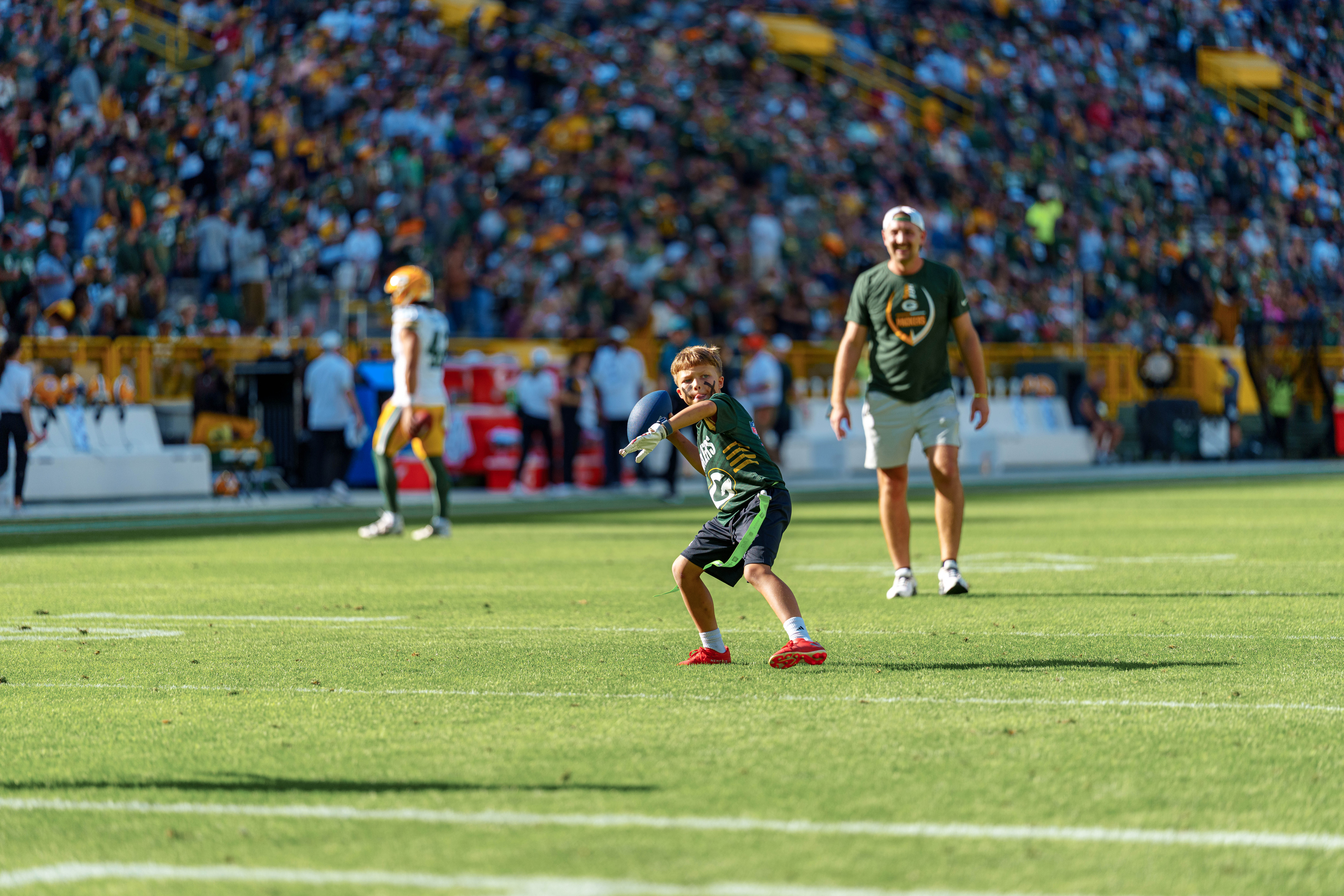 The Verona Area flag football team takes the field during halftime of an NFL preseason game between the Green Bay Packers and Seattle Seahawks at Lambeau Field in Green Bay, Wisconsin, on August 23, 2025. Photography by Ross Harried for Second Crop Sports.